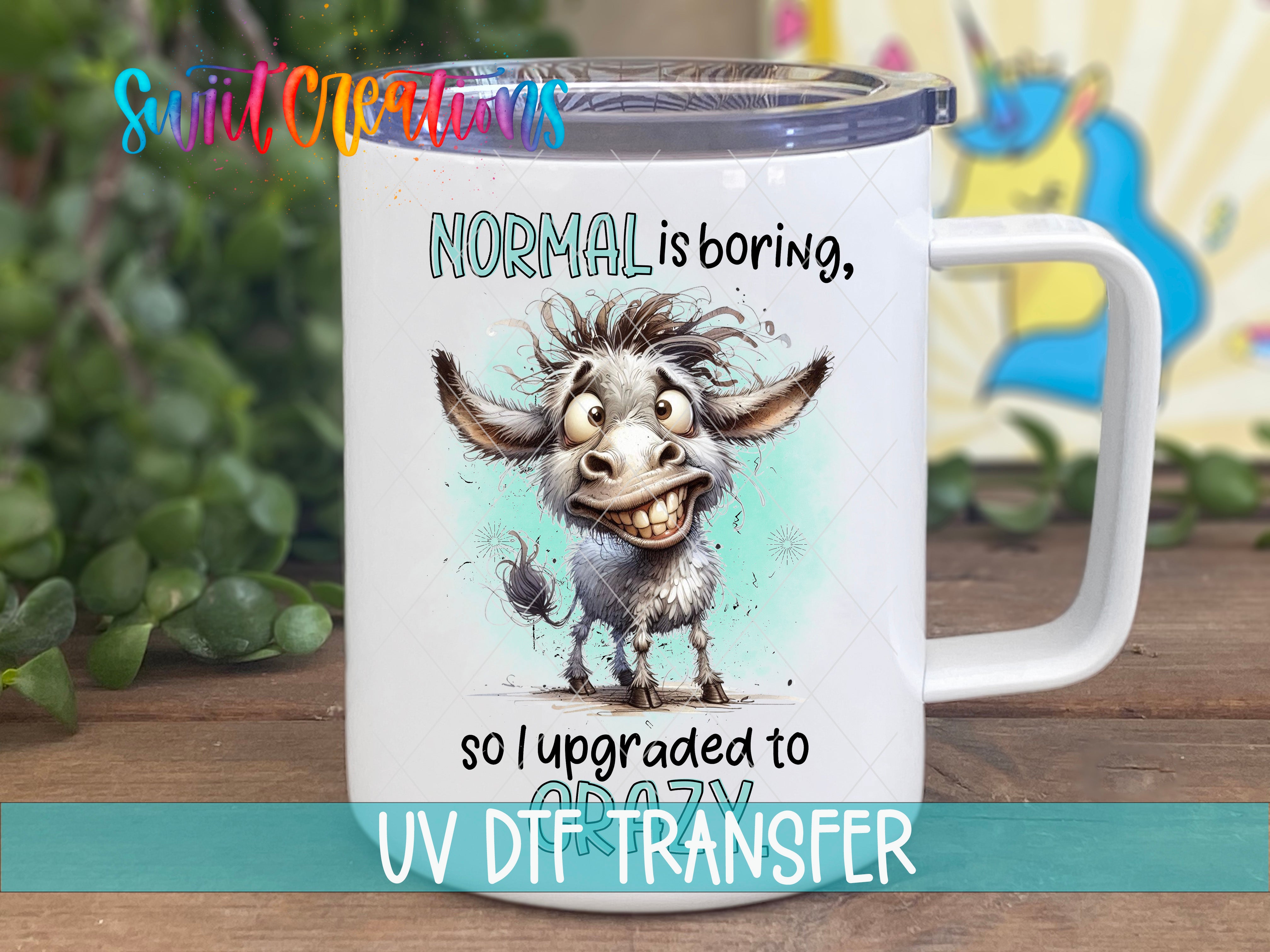 A white mug with a cartoon donkey and text that says "NORMAL is boring, so I upgraded to crazy".