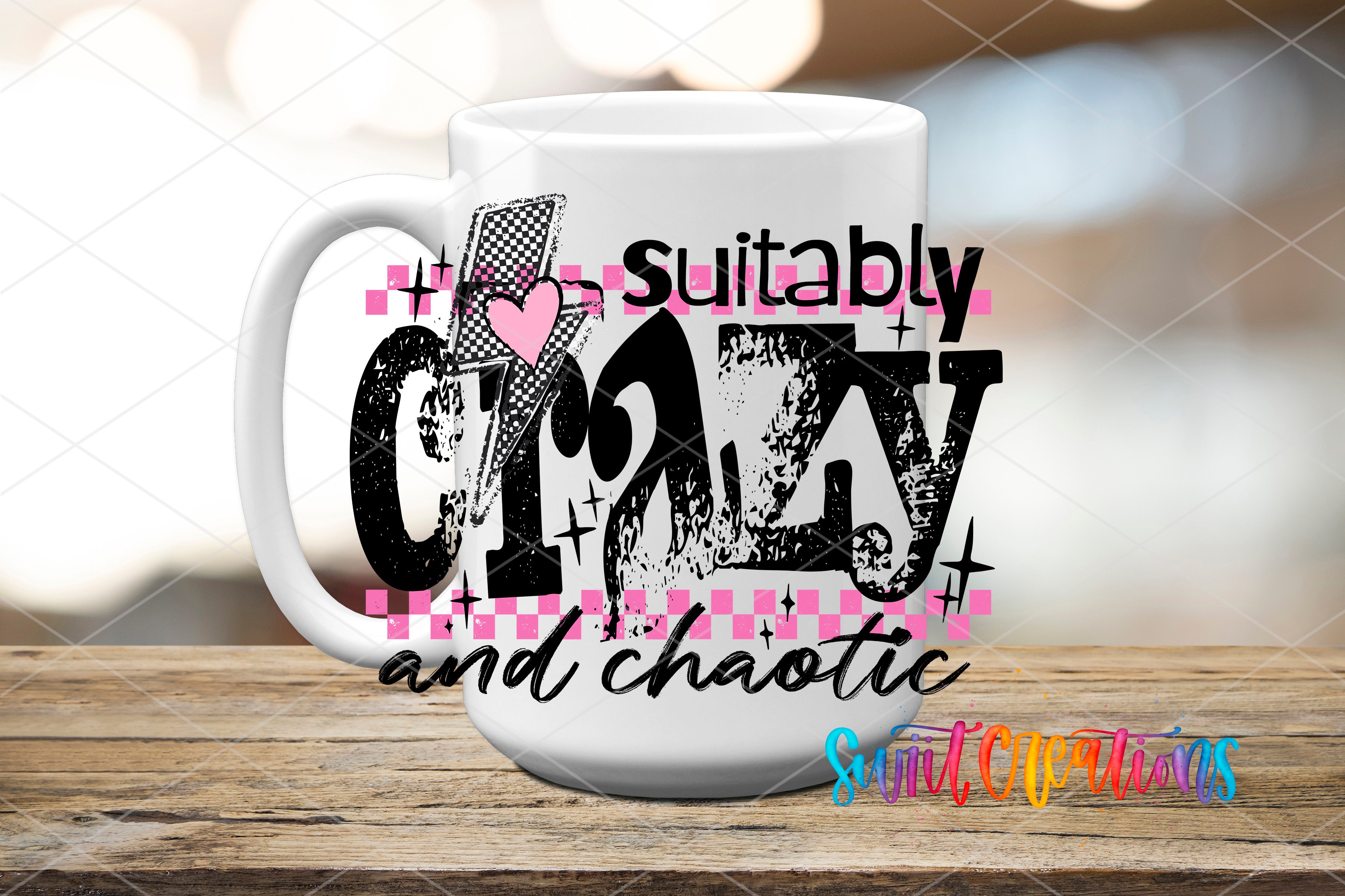 A white mug with a graphic design featuring the text "suitable crazy and chaotic" along with a heart symbol and checkered pattern.
