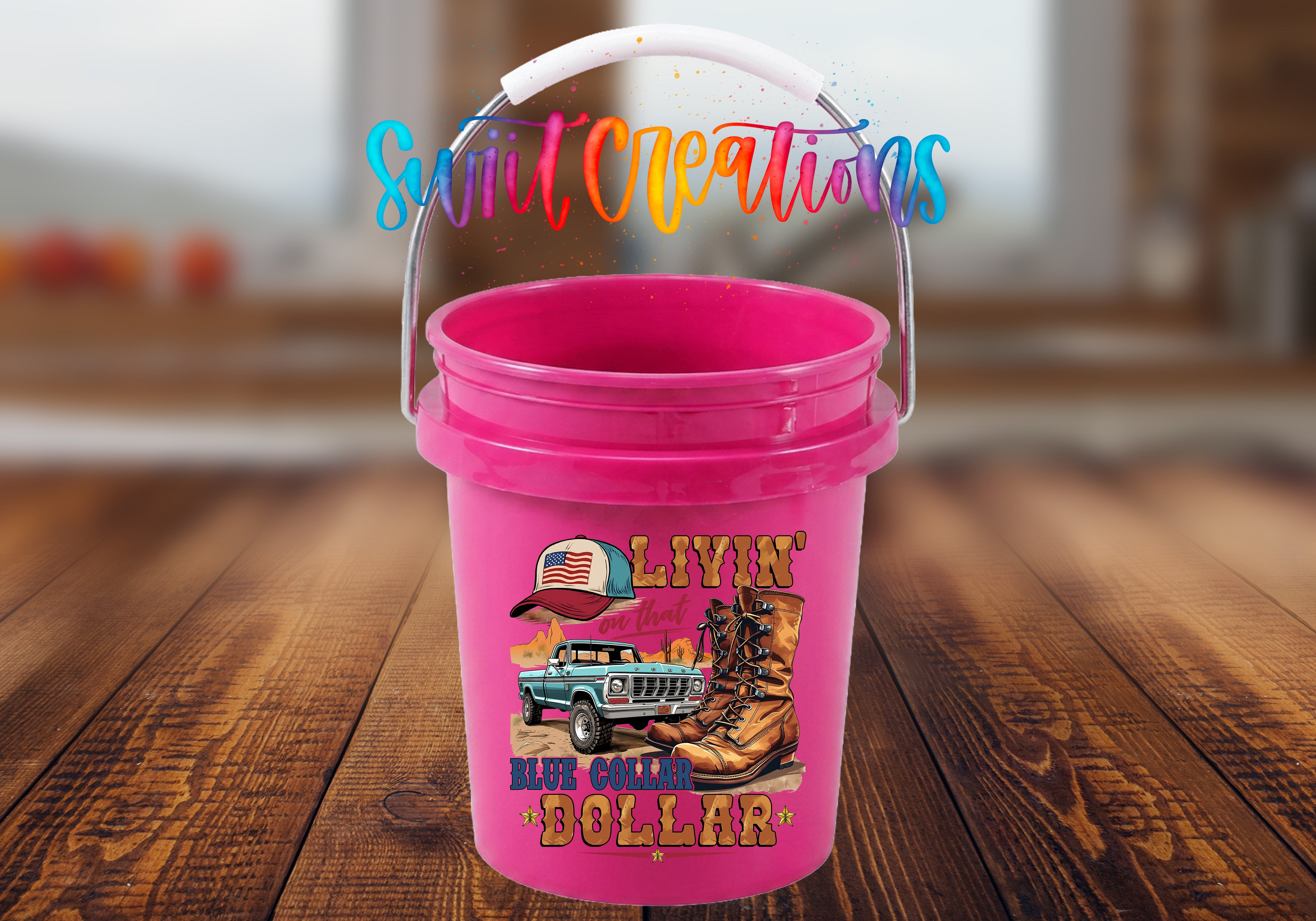 A pink bucket with a printed design of a truck and cowboy hat, along with the text "LIVIN' IN THE COUNTRY" and "BLUE COLLAR DOLLAR".