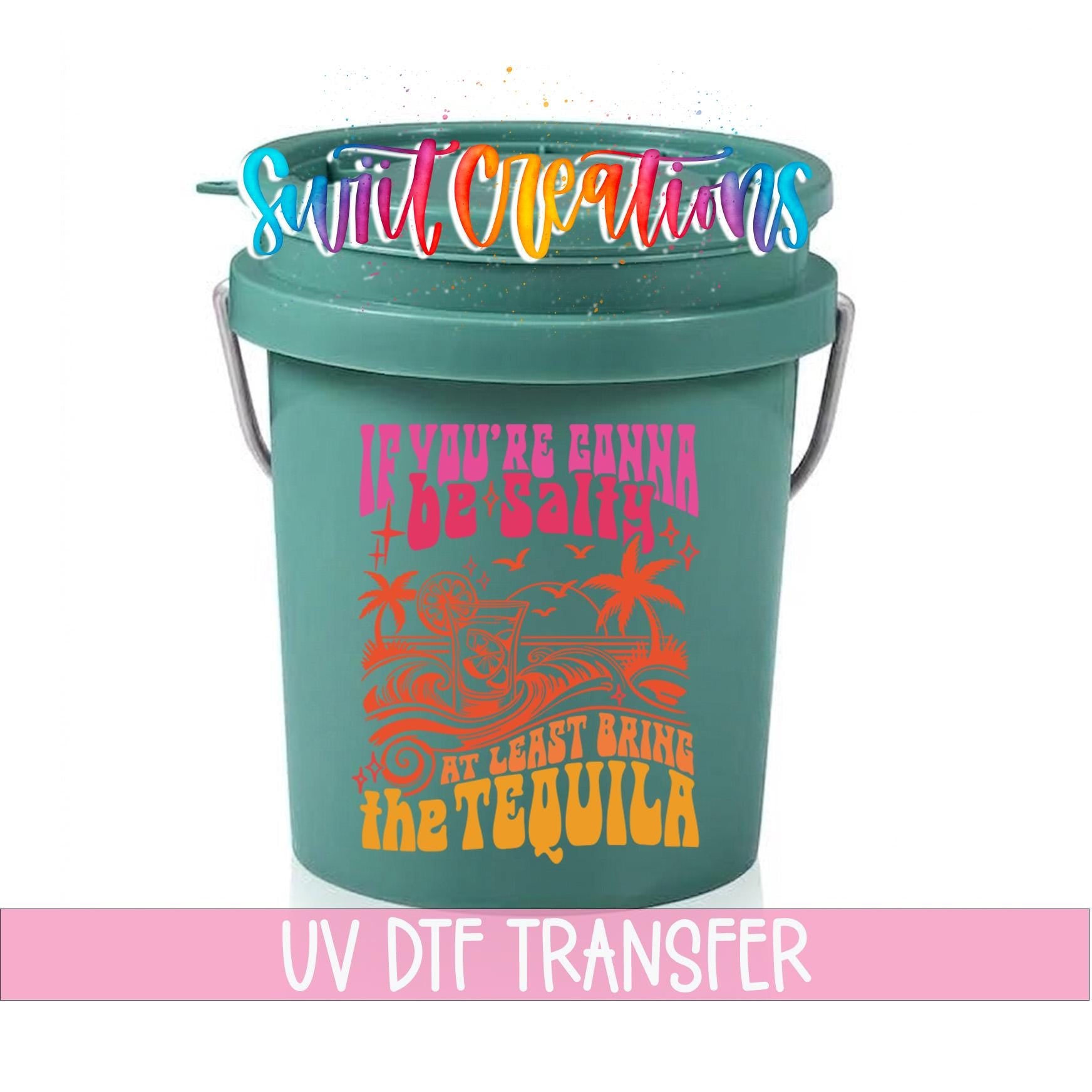 A green bucket with a colorful graphic and text printed on it.