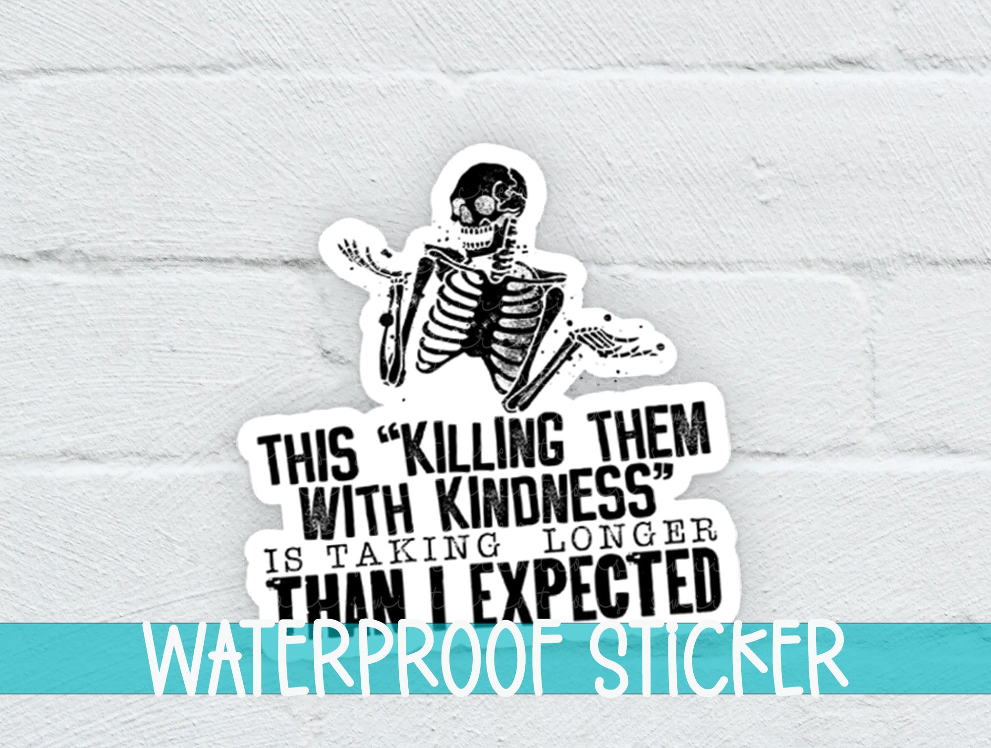 a sticker of a skeleton on a white brick wall