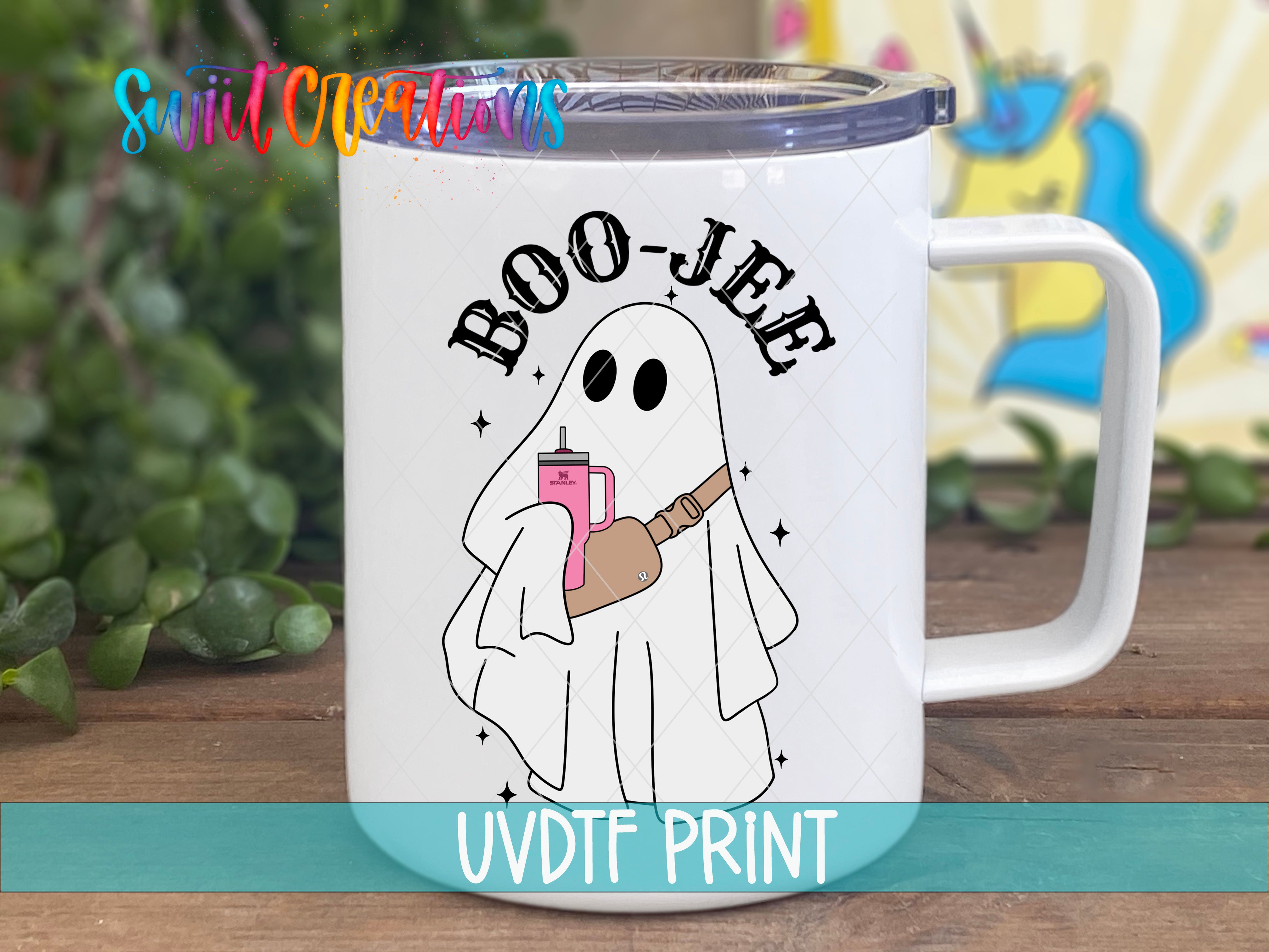A white mug with a cartoon ghost holding a pink object and the text "BOO-JEE" printed on it.