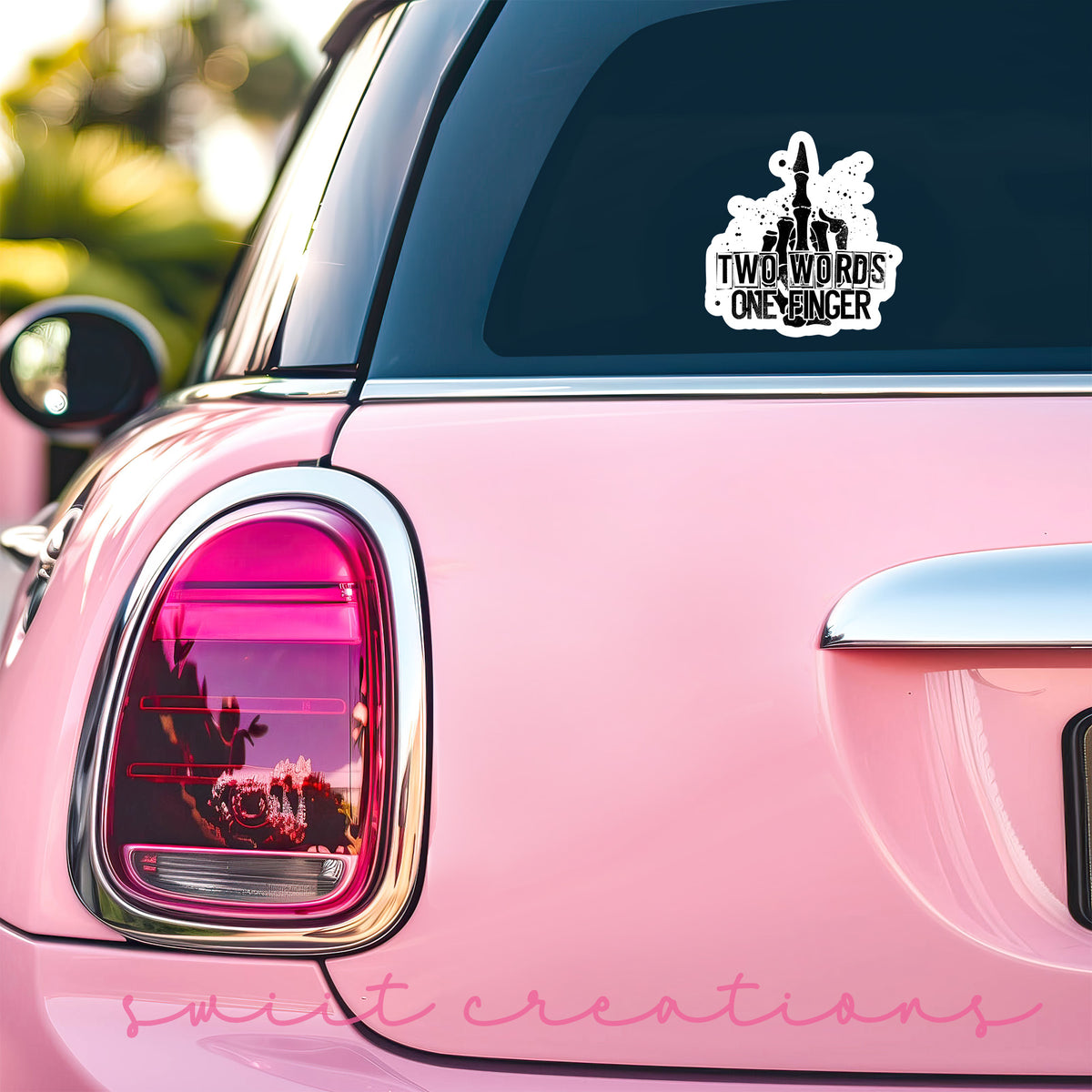 a pink car with a sticker on it