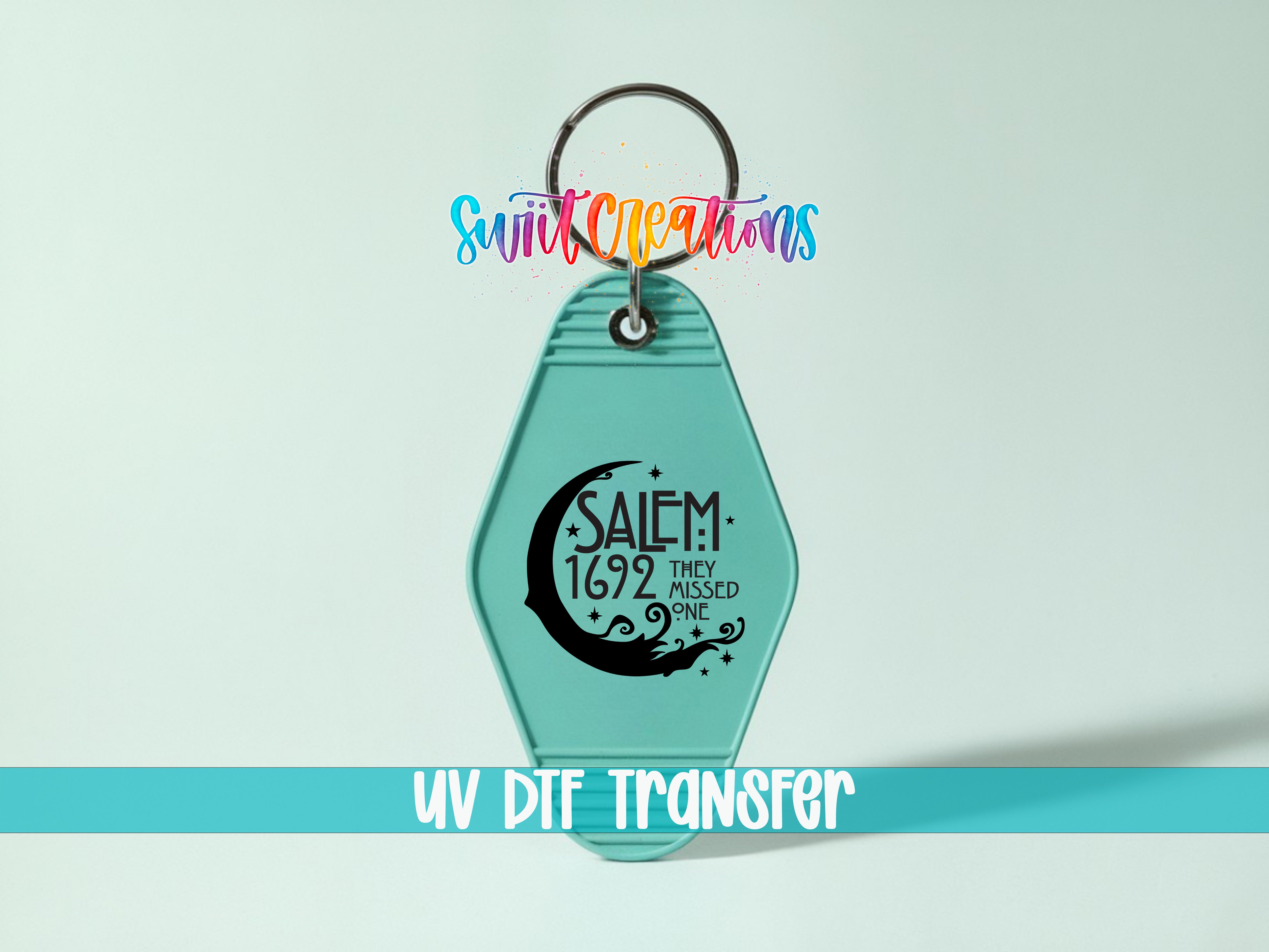 A turquoise keychain with a keyring and a printed message on it, against a light blue background.