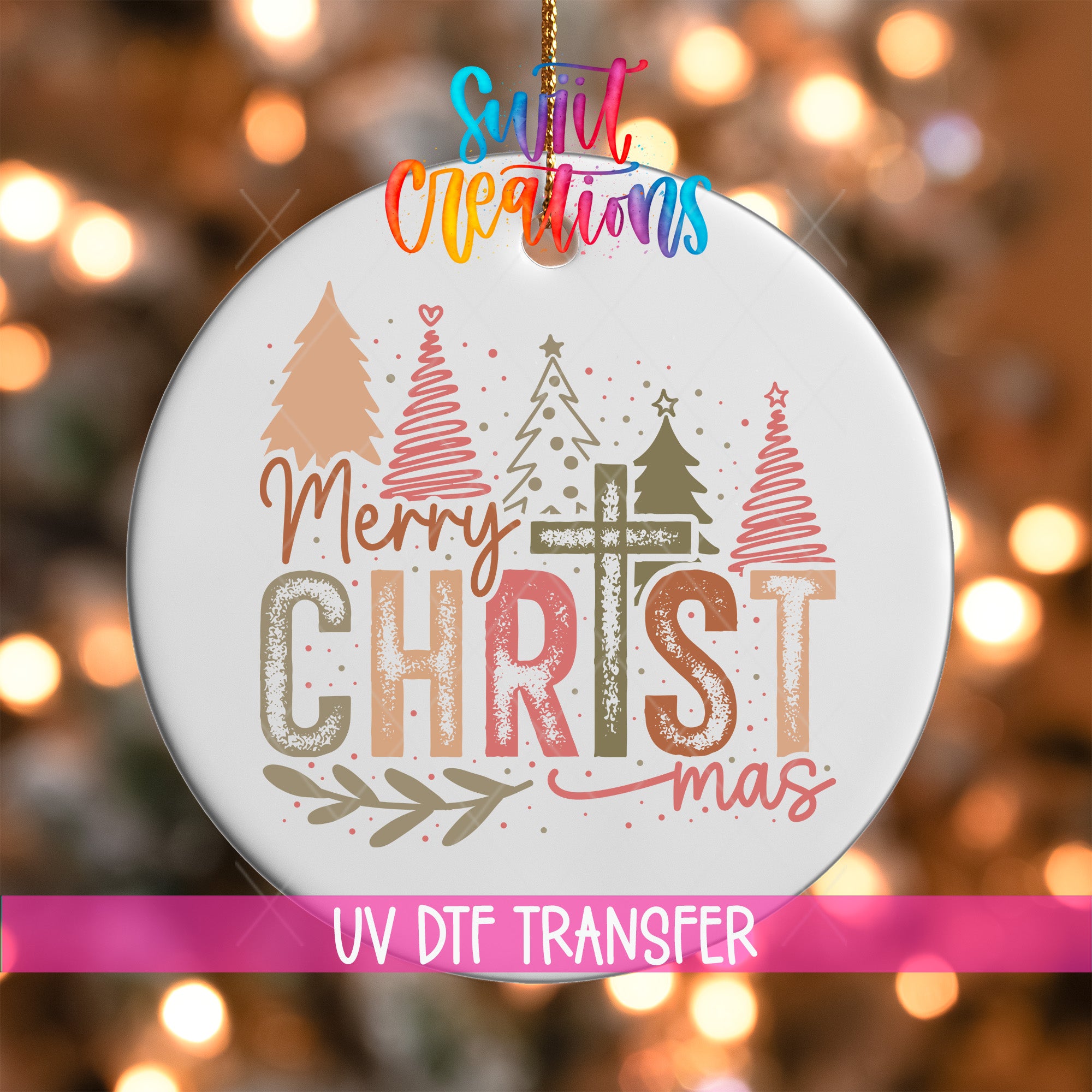 A white Christmas ornament with the text "Merry Christmas" and "mas" written on it, along with decorative Christmas trees and ornaments. The ornament is hanging against a background with colorful lights.