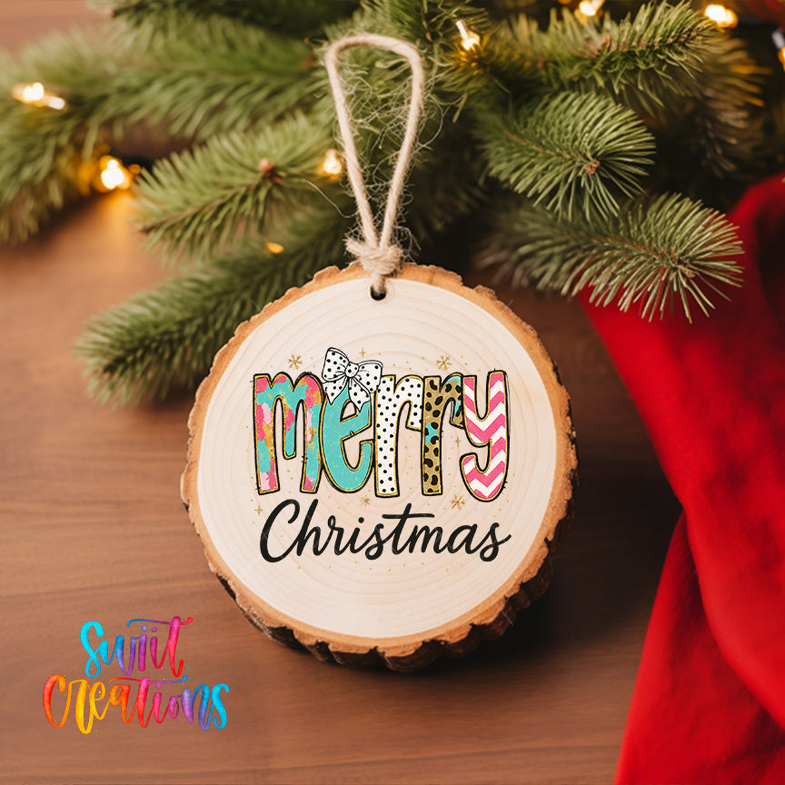 A wooden ornament with the word "MERRY" written on it, hanging on a Christmas tree.