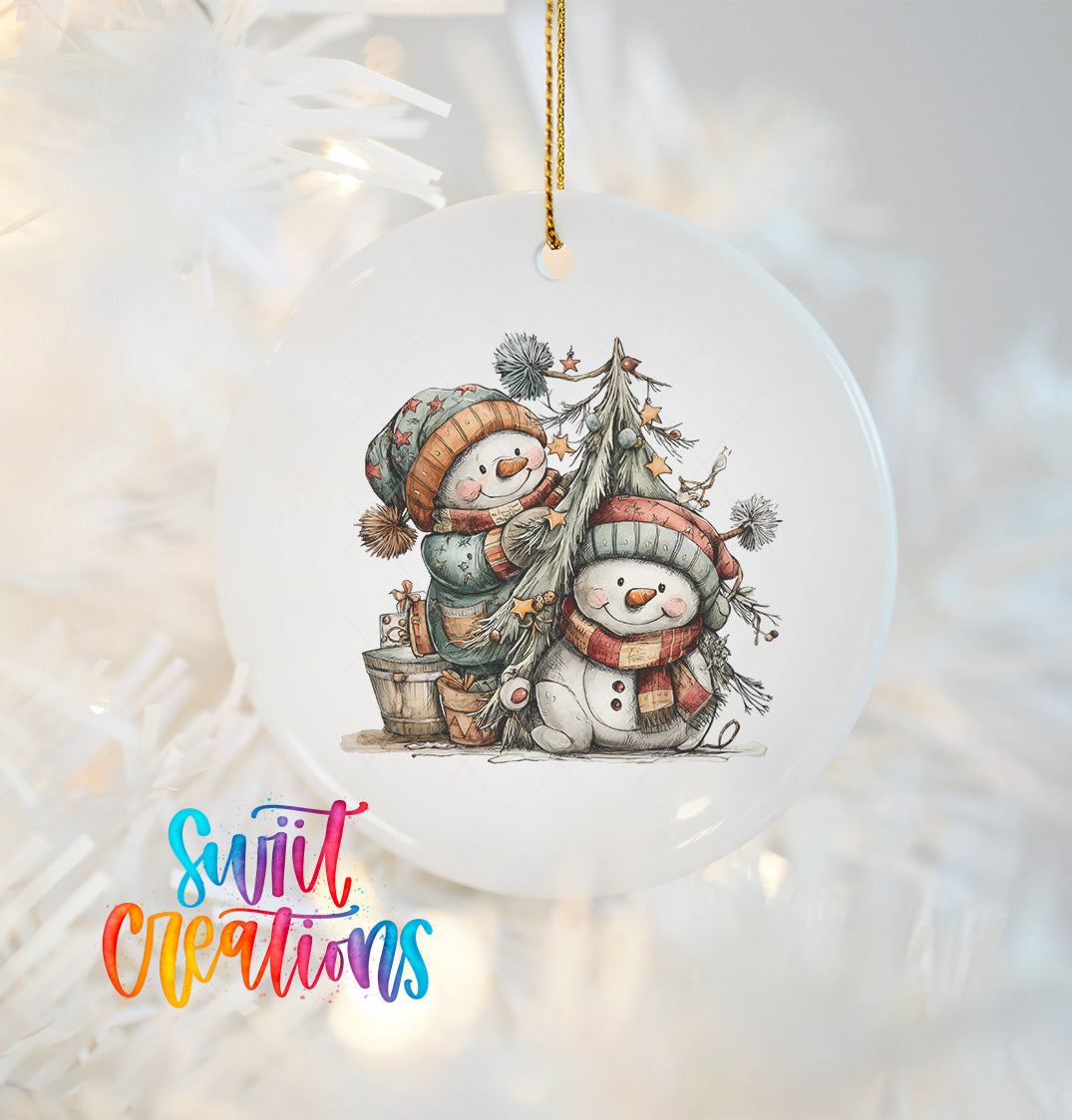 A white ornament with a snowman and a tree, featuring two snowmen and a tree with decorations.
