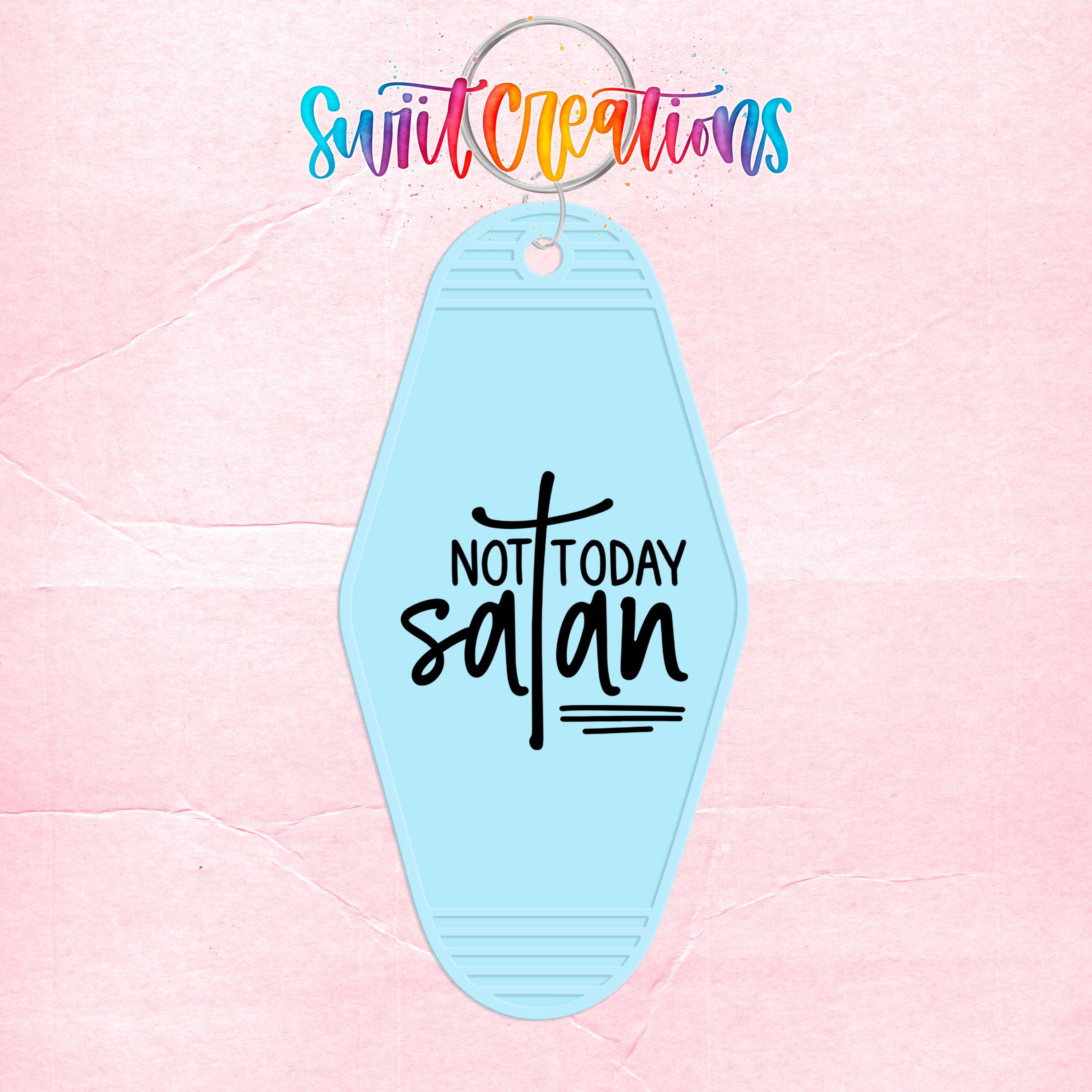 A keychain with the text "NOT TODAY SATAN" printed on it, set against a pink background.