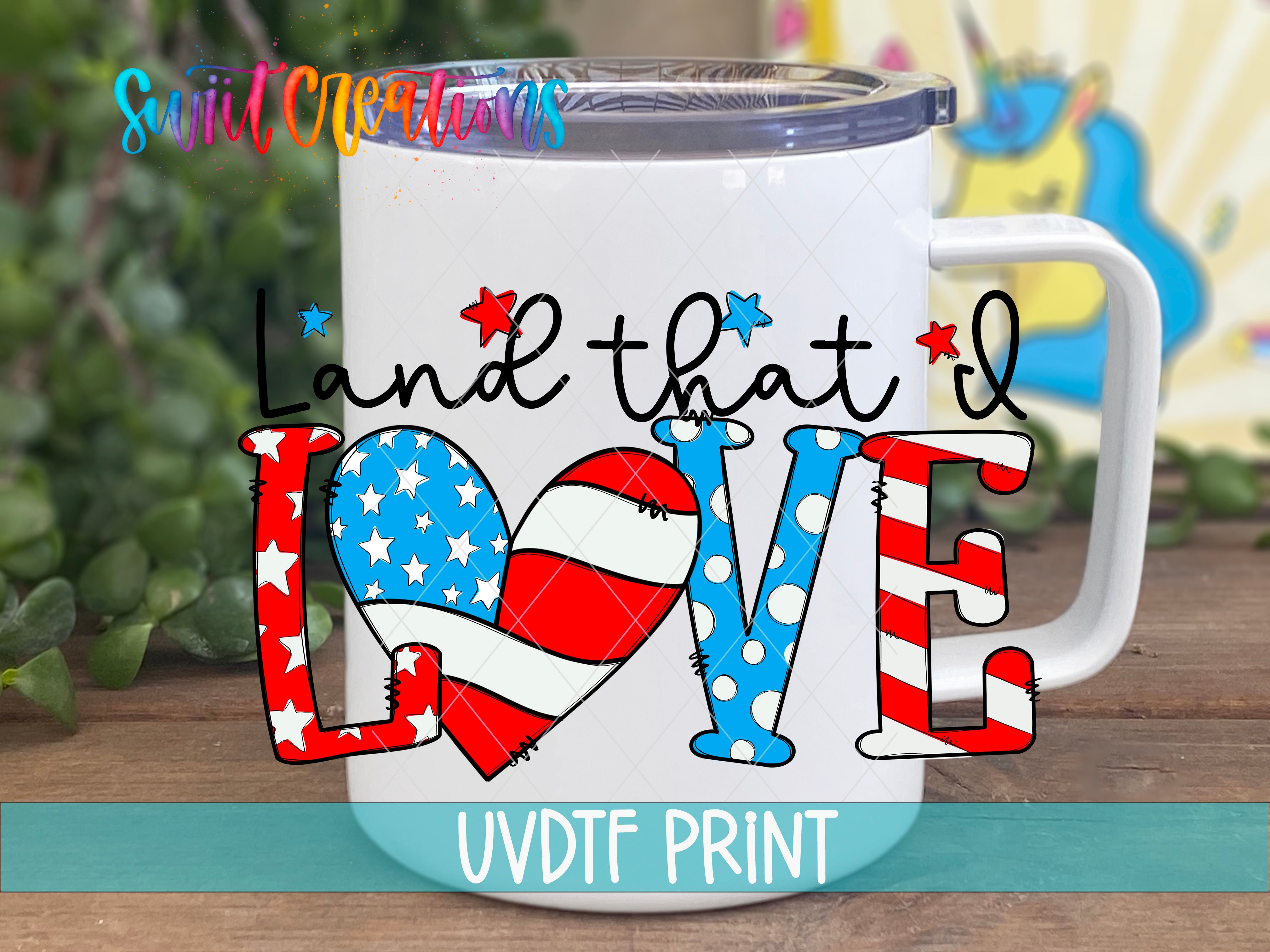 A white mug with a patriotic design featuring the words "Land that I Love" and an American flag pattern.