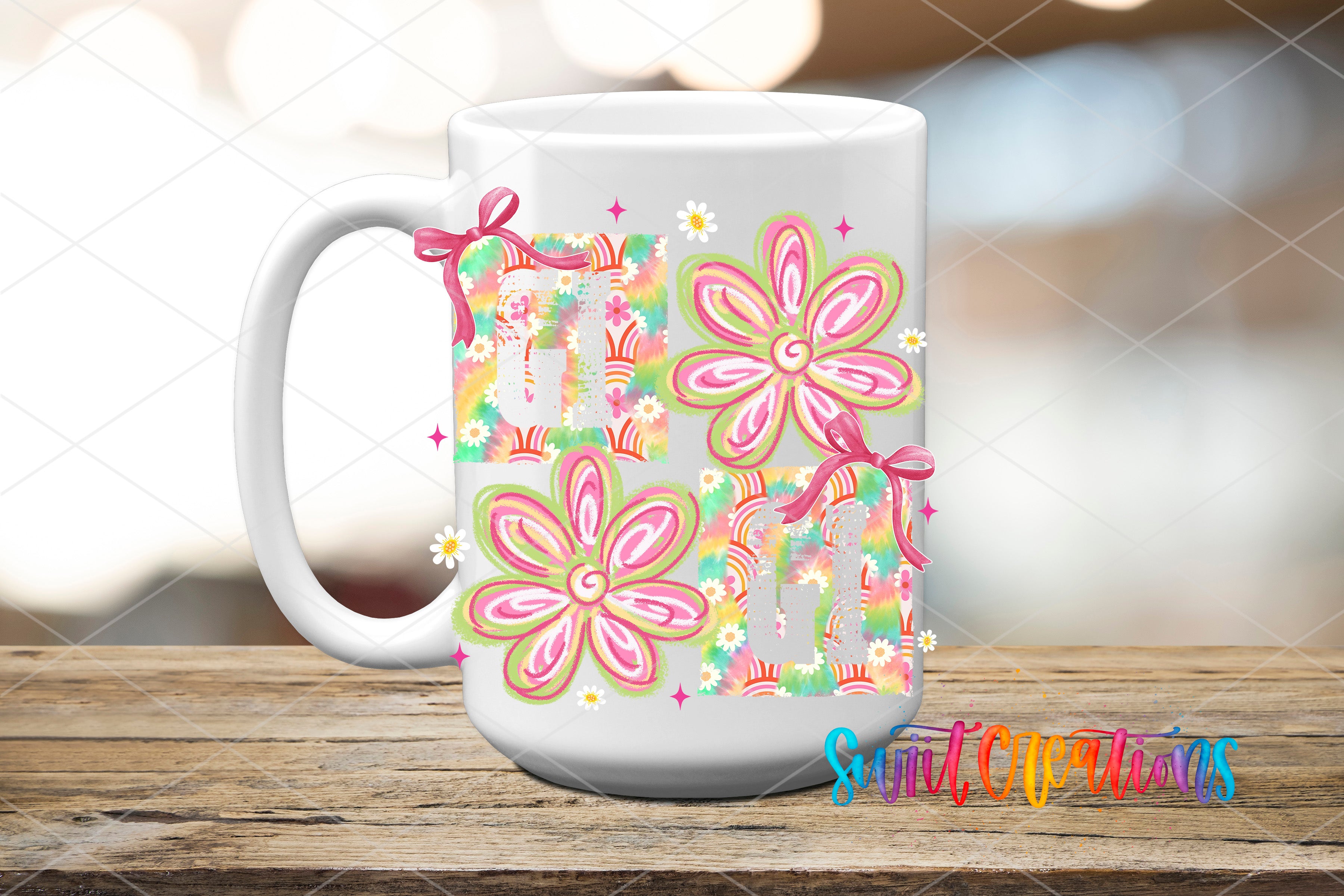 A white ceramic mug with a colorful floral design featuring pink and green flowers, along with other decorative elements.