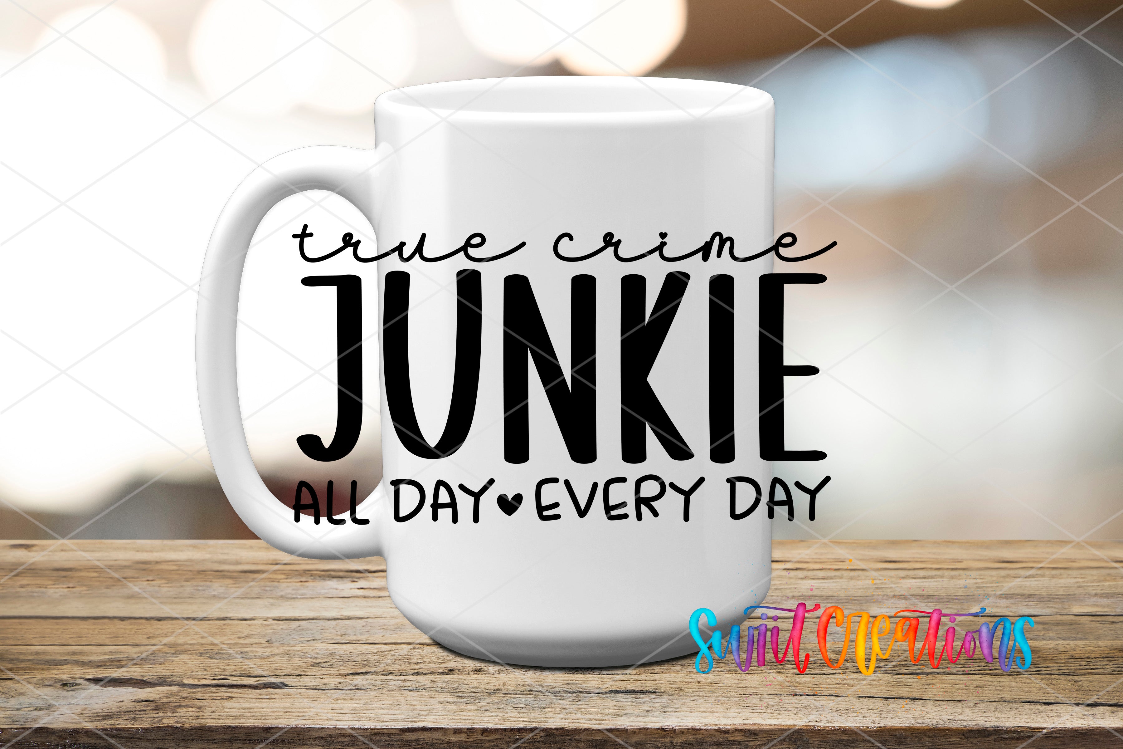 A white mug with the text "True Crime Junkie All Day Every Day" printed on it, placed on a wooden surface.