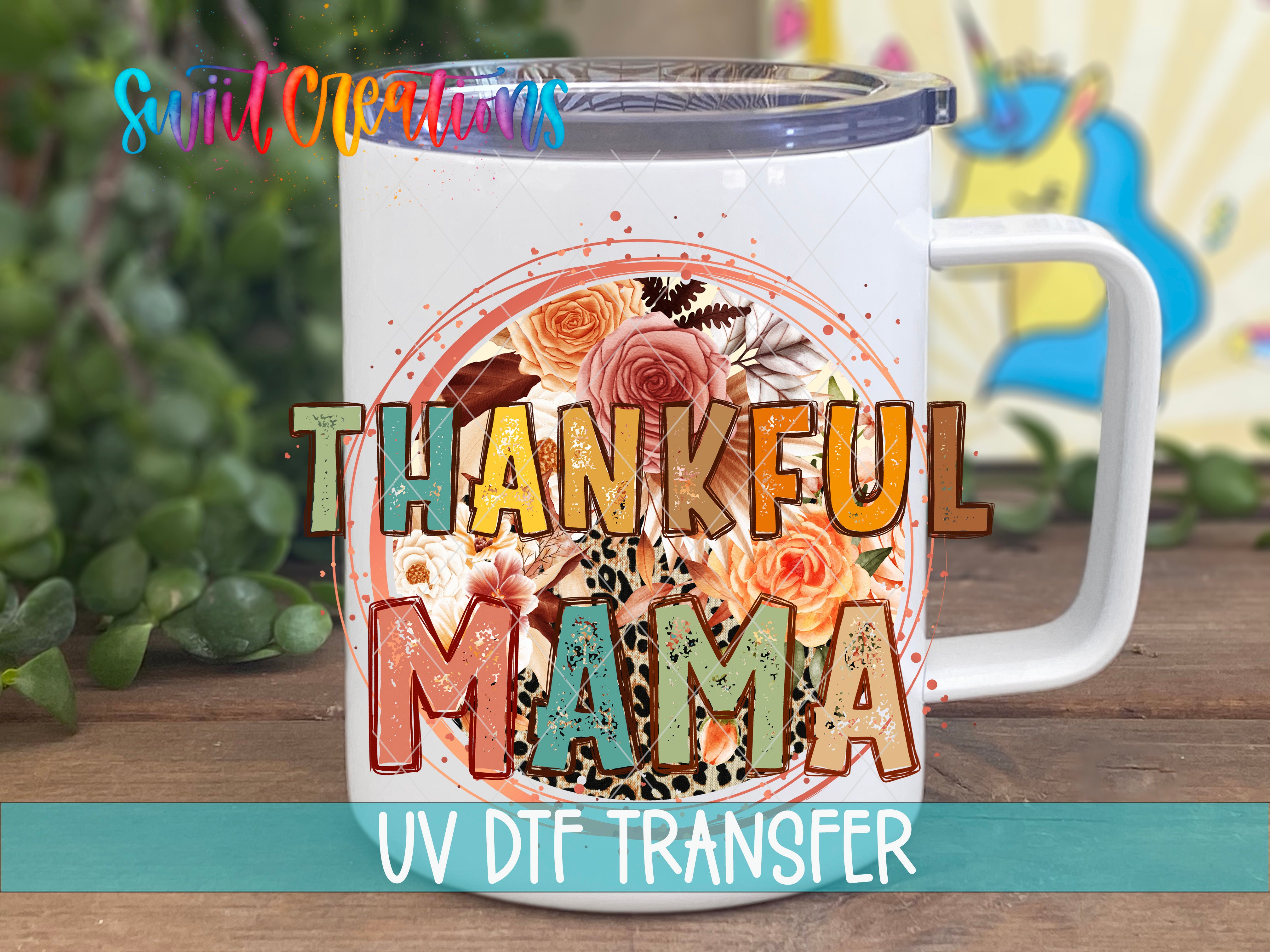 A white ceramic mug with a colorful floral design and the text "THANKFUL MAMA" printed on it.