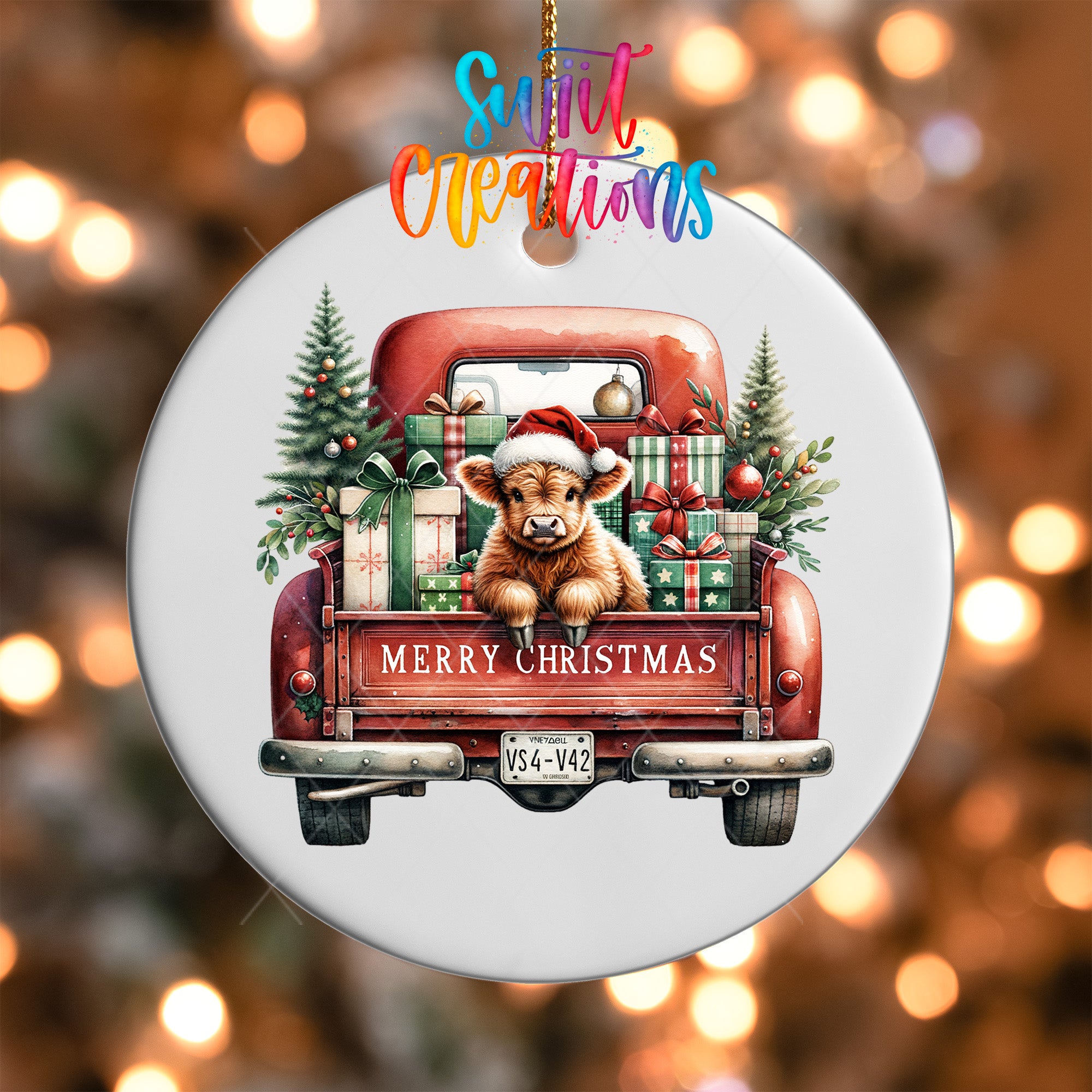 A white Christmas ornament with a red truck and a cow wearing a Santa hat.