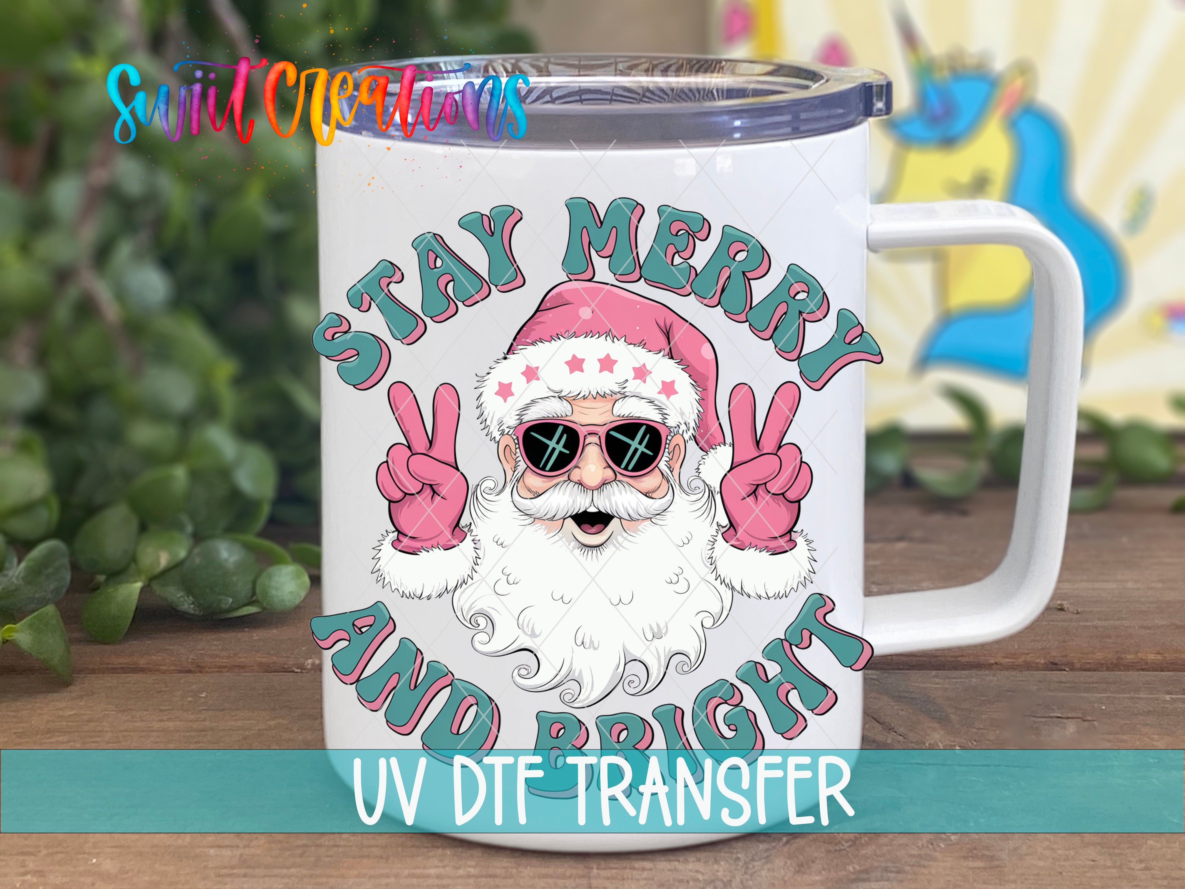 A mug with a cartoon Santa Claus wearing sunglasses and giving peace signs, with the text "STAY MERRY AND BRIGHT" and "UV DFT TRANSFER" printed on it.
