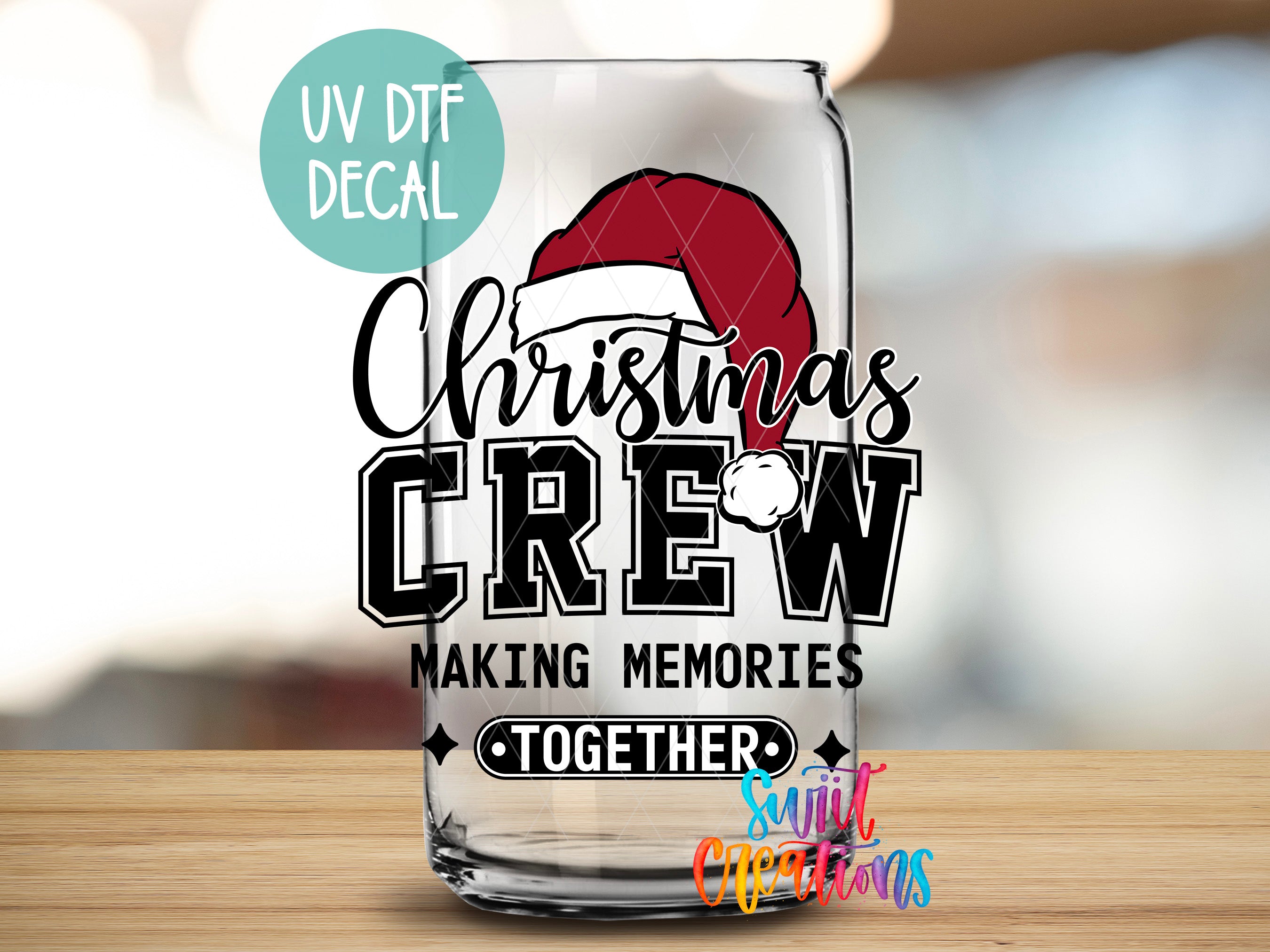 a glass with a santa hat on it sitting on a table