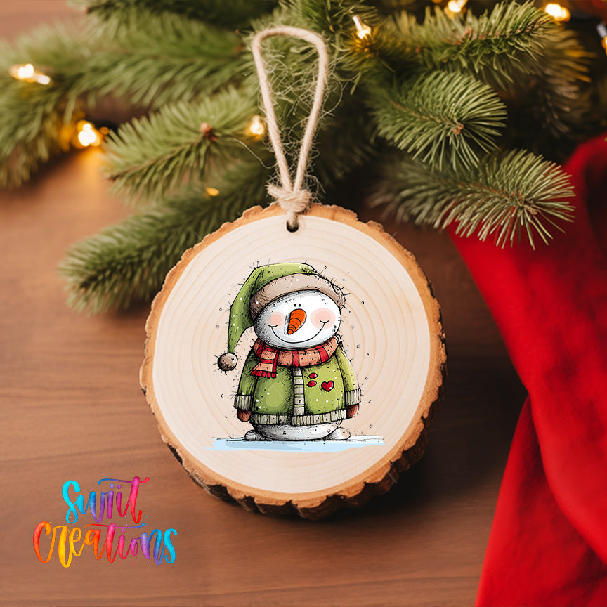 A wooden ornament featuring a smiling snowman is hanging on a Christmas tree, with a red cloth visible in the background.