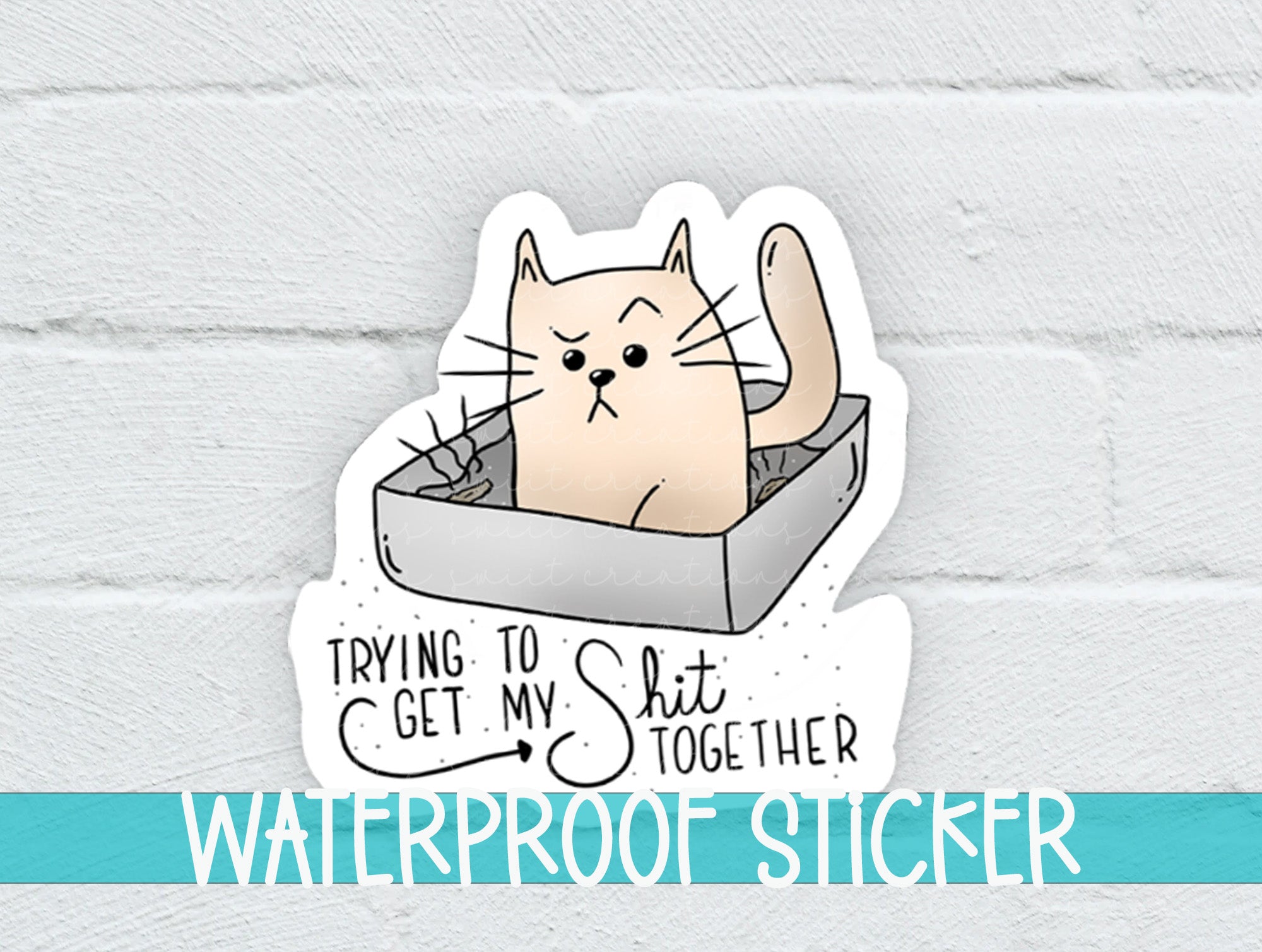 a sticker of a cat in a box with the words trying to get my