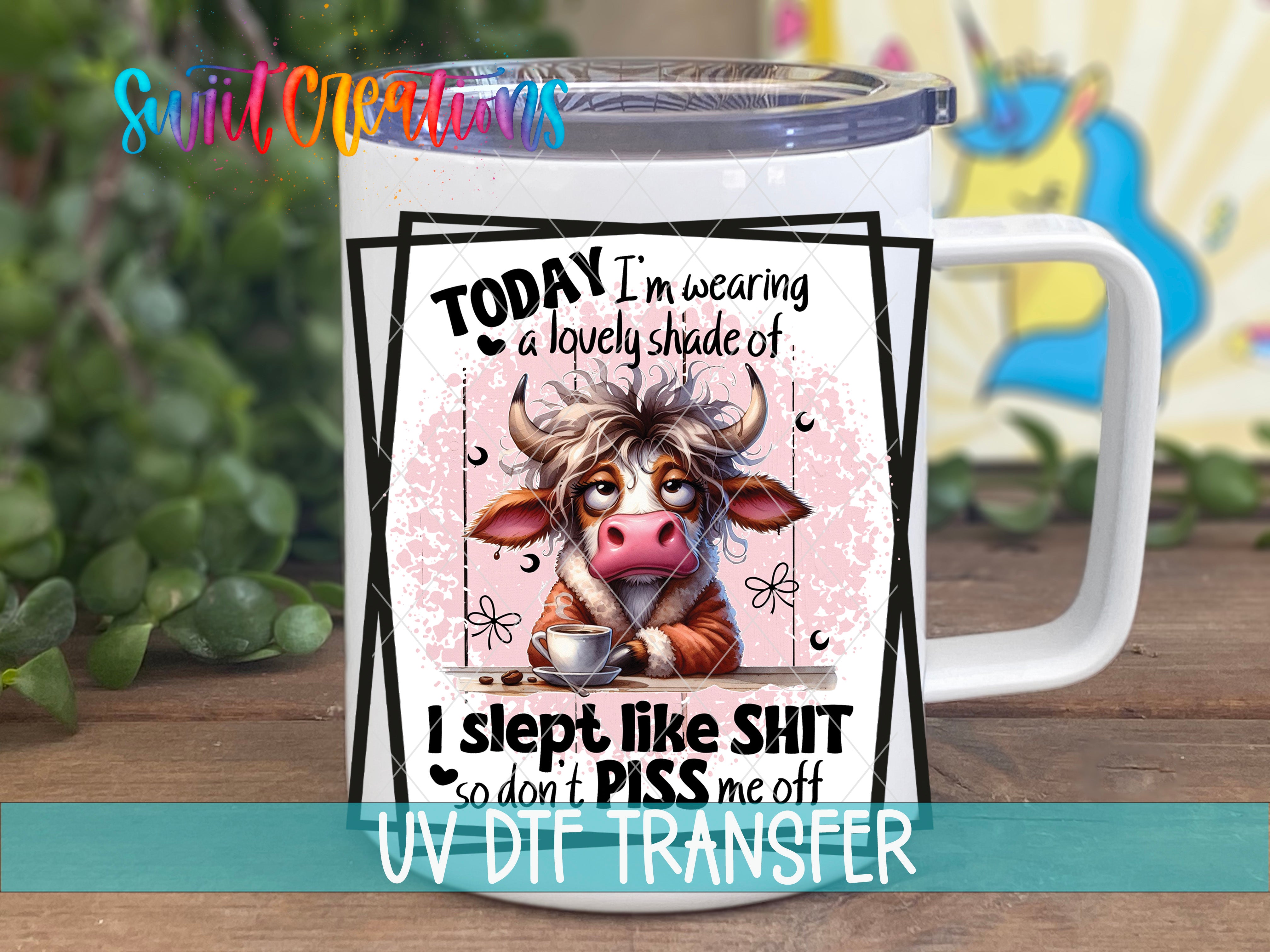 A mug with a cartoon cow design and text on it.