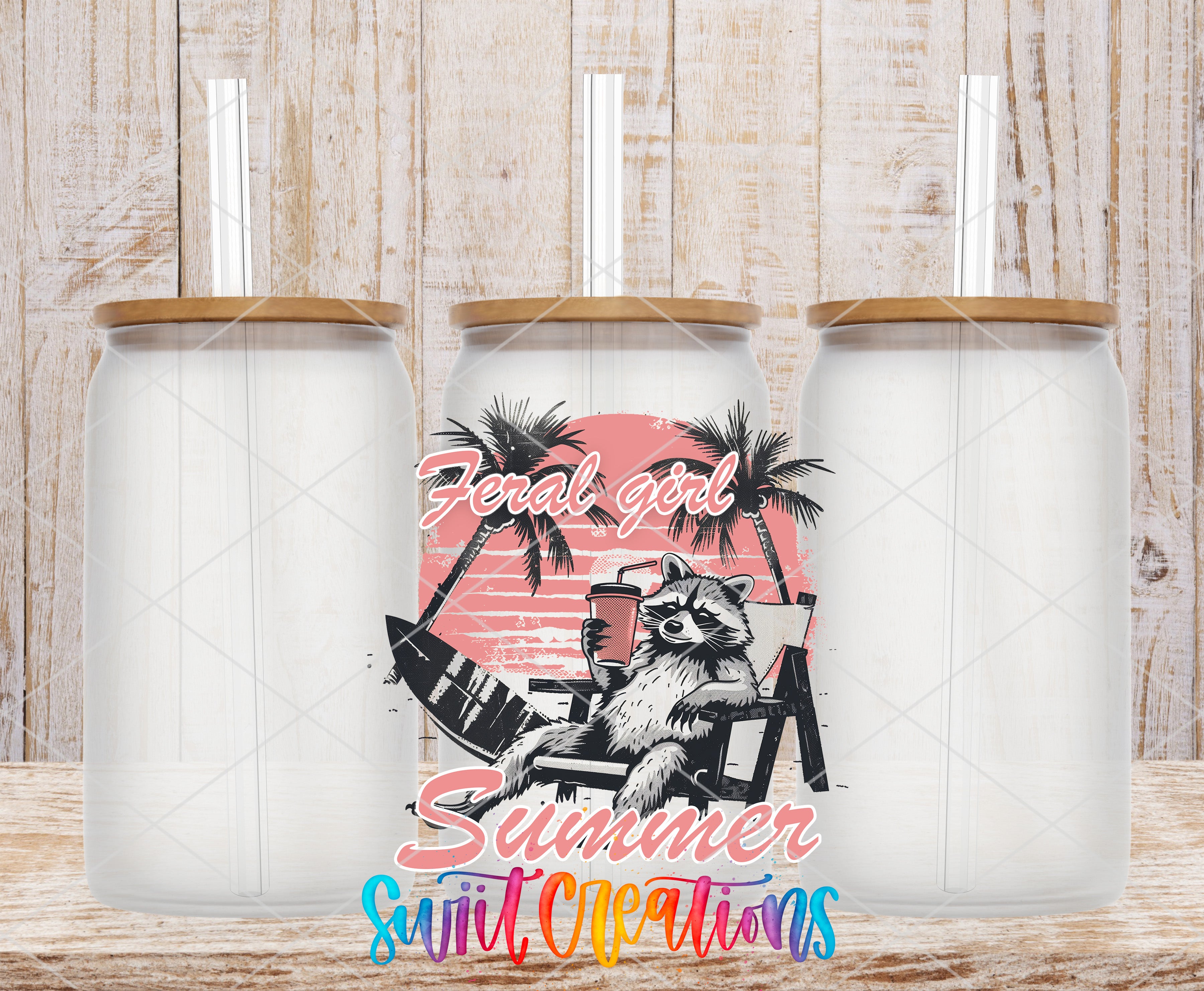 three clear glass tumblers with straws, each containing a straw. The tumblers are arranged in a row, with the middle one having a colorful design depicting a raccoon sitting on a beach chair and holding a surfboard. The design includes palm trees and a sunset, creating a beach-themed atmosphere. The text "Feral Girl Summer" is displayed in a stylized font, suggesting a summer-themed design or branding.