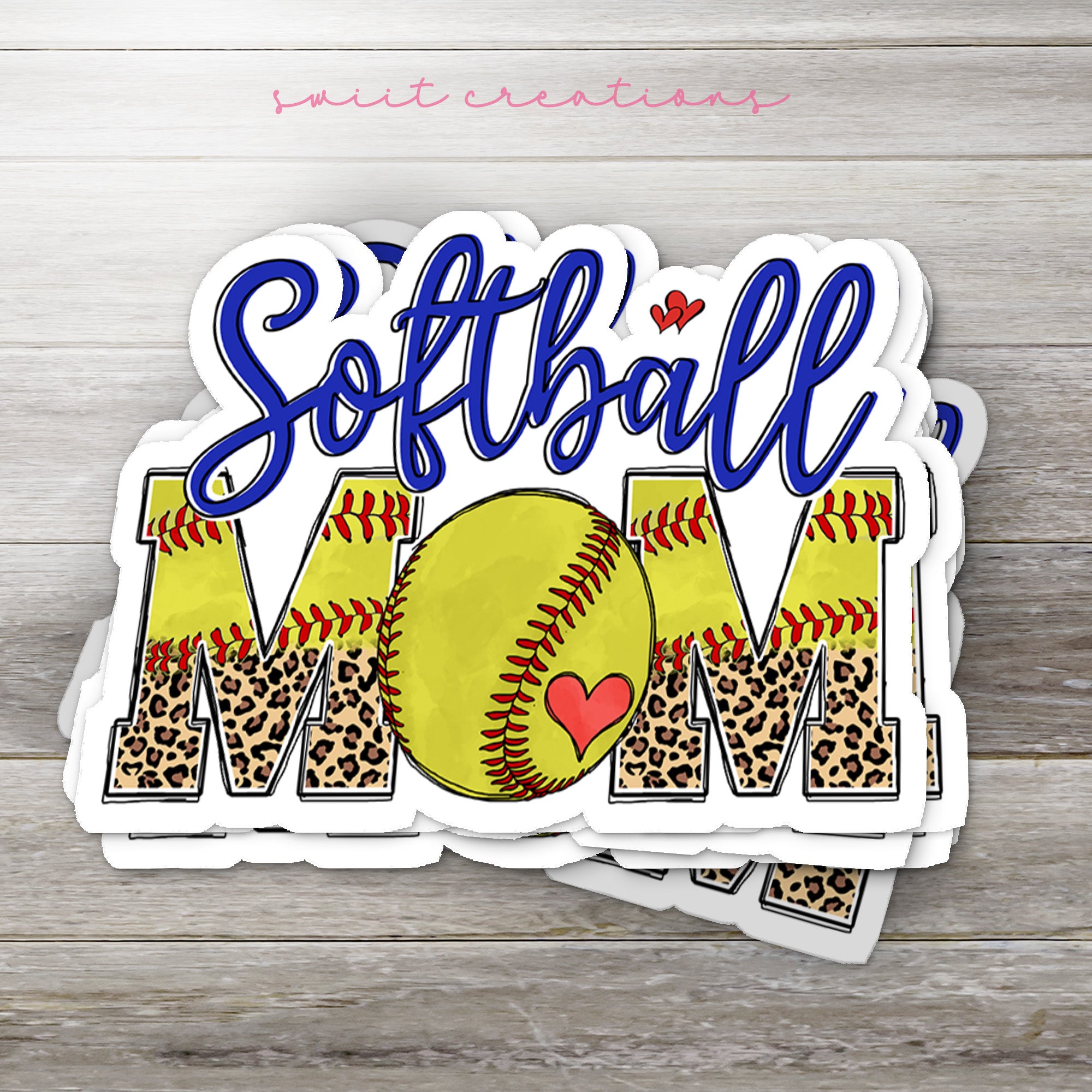 a softball mom sticker on top of a wooden table