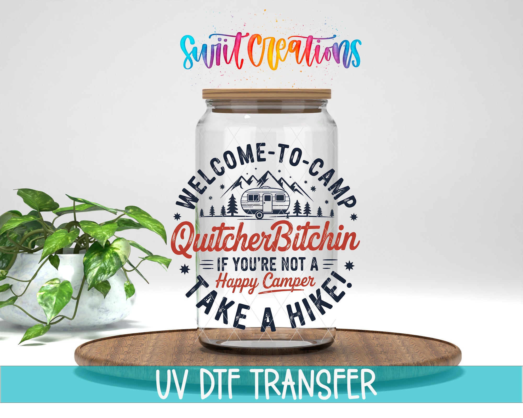 a glass jar with a label that says "Welcome to Camp Quitchin! If you're not a happy camper, take a hike!" The jar is placed on a wooden surface, and there is a potted plant in the background.