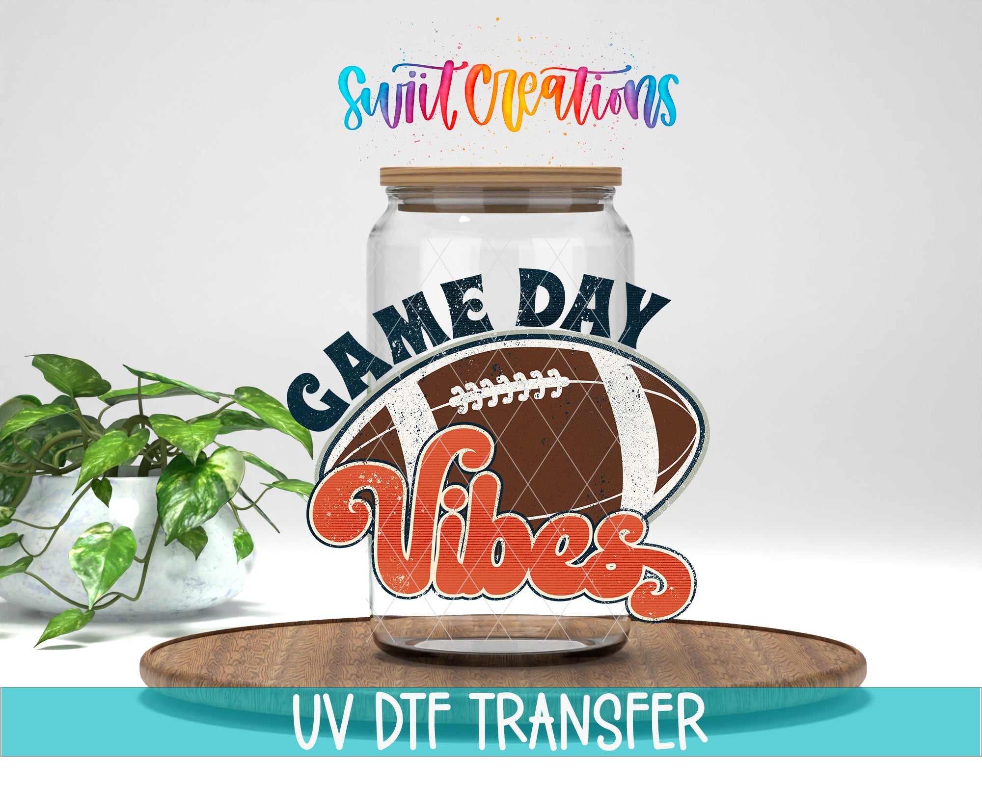 a glass jar with a football graphic and the text "GAME DAY VIBES" printed on it, along with a plant and a wooden tray in the background.