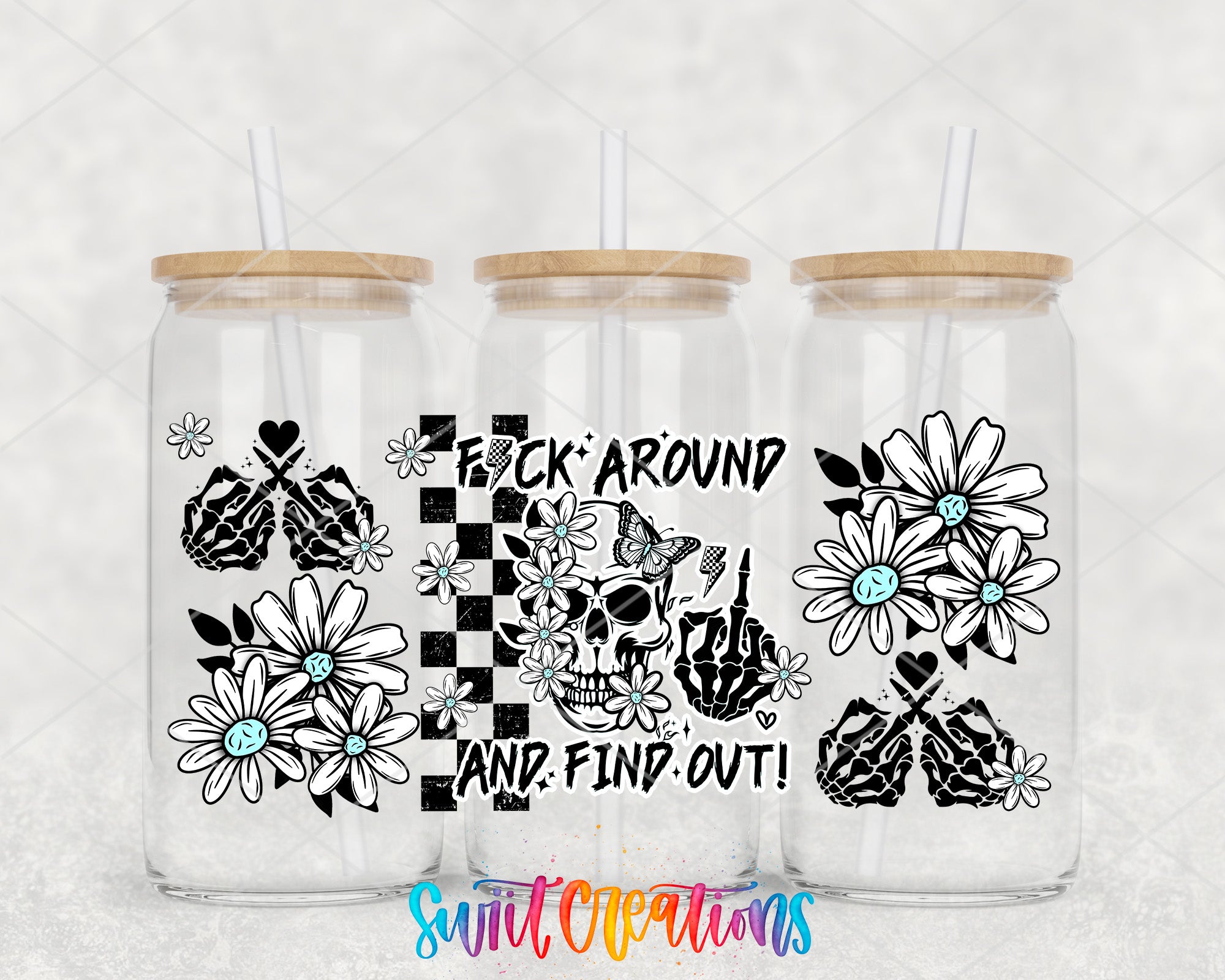three clear glass tumblers with black and white floral designs and text printed on them.