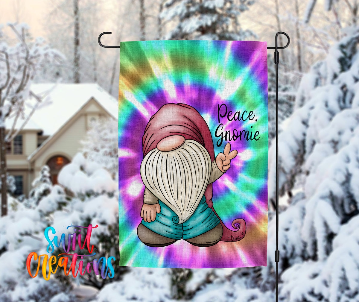 A colorful tie-dye flag featuring a gnome character with a peace sign, set against a snowy winter landscape with a house and trees in the background.