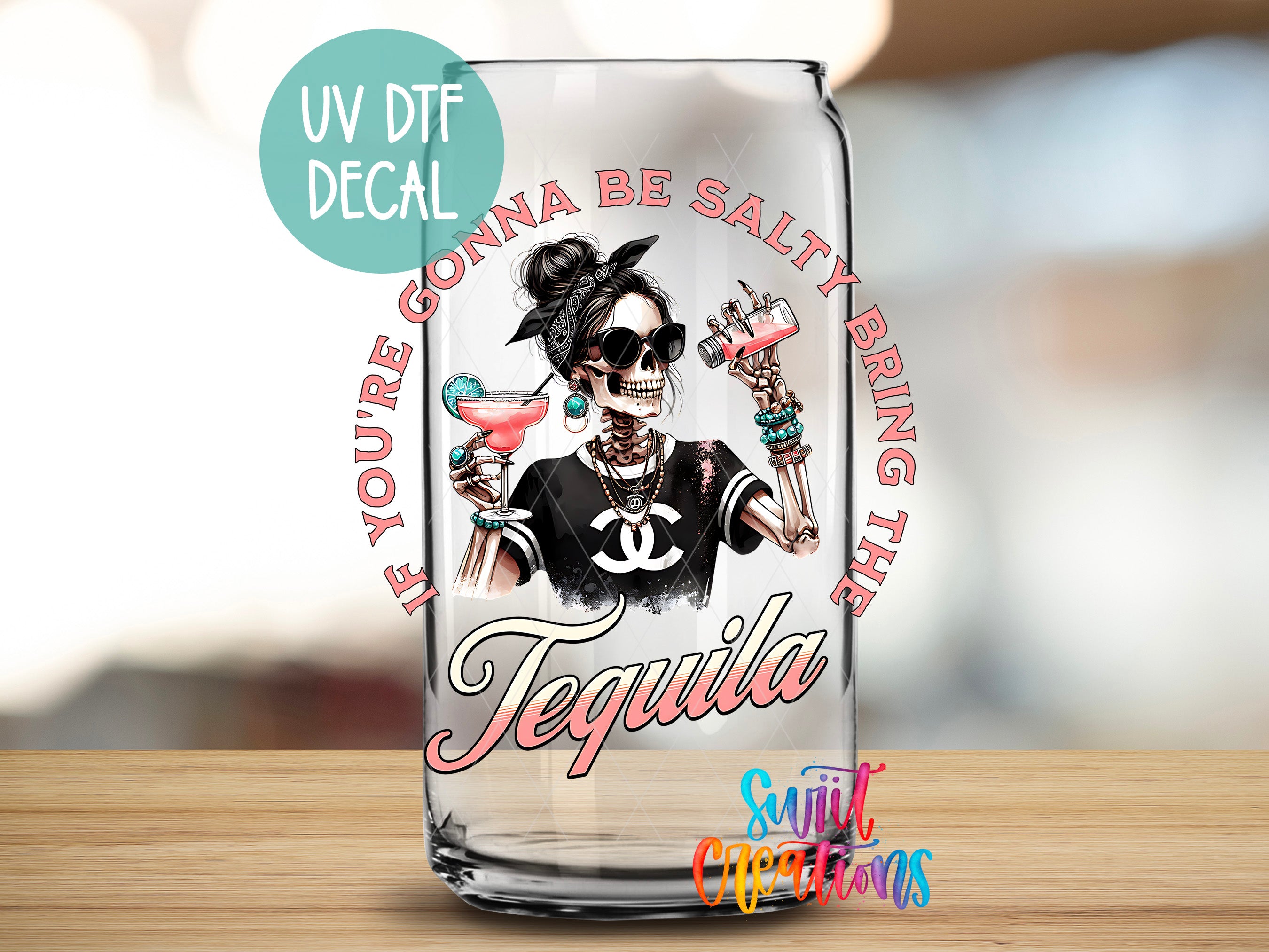 a glass with a picture of a woman with a skull on it