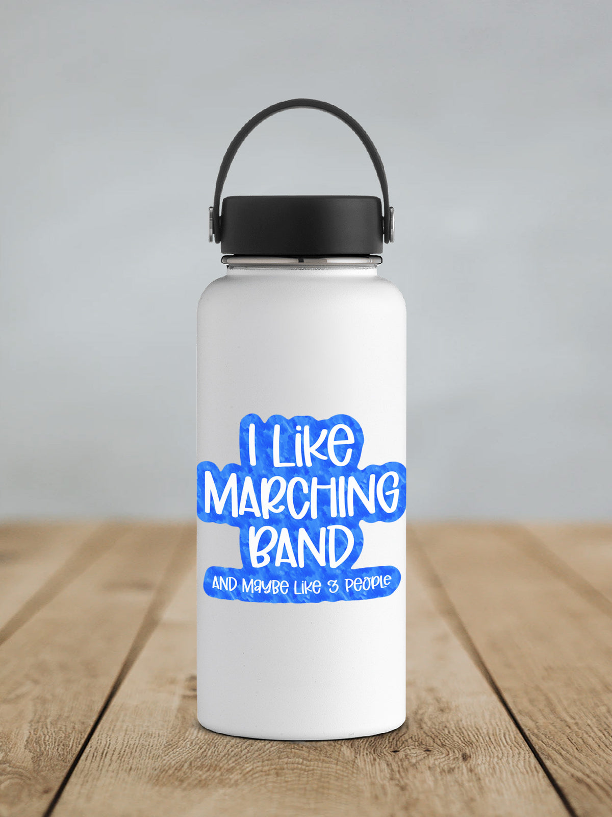 a white water bottle sitting on top of a wooden table