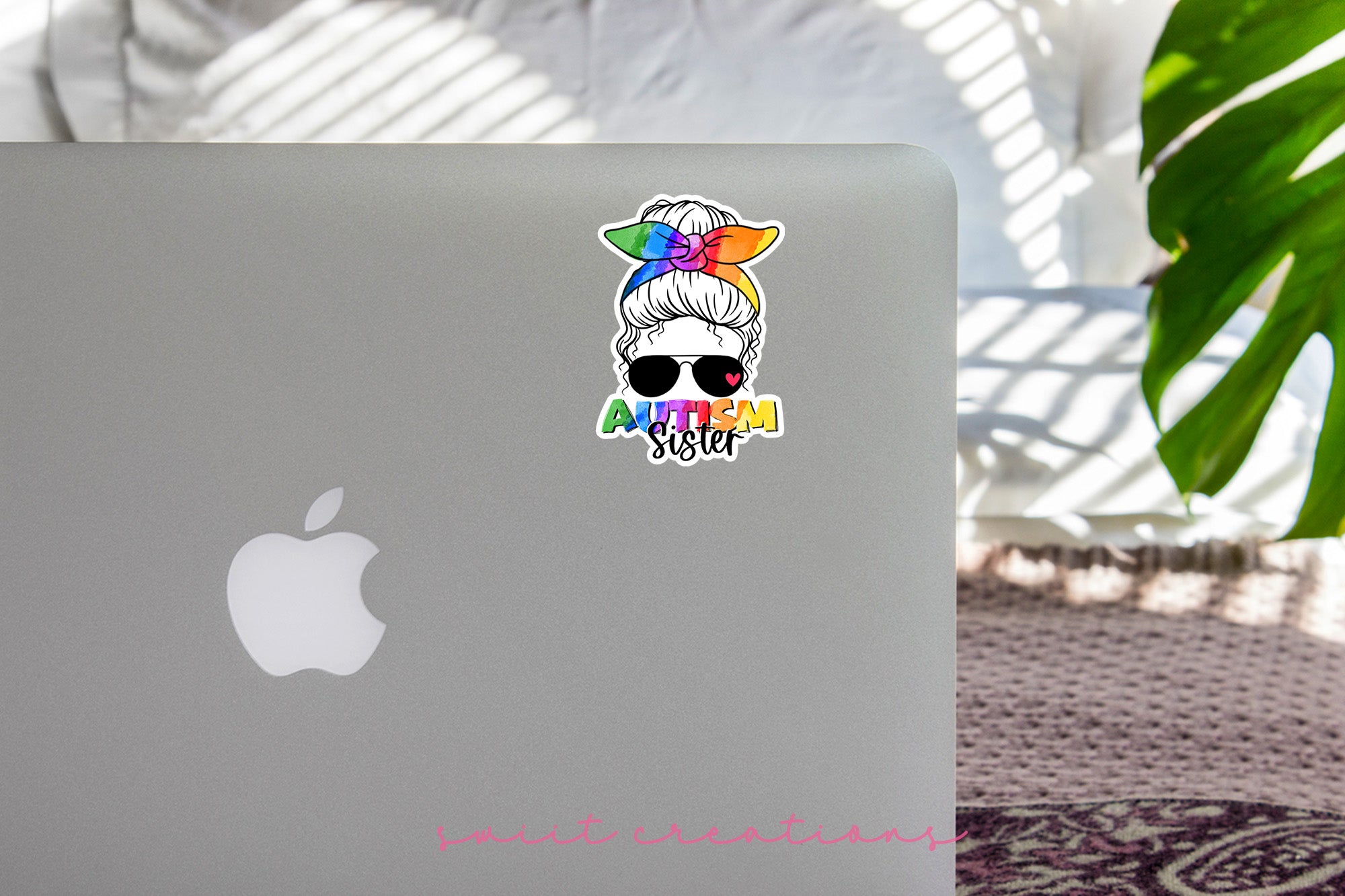 a laptop with a sticker of a woman wearing sunglasses