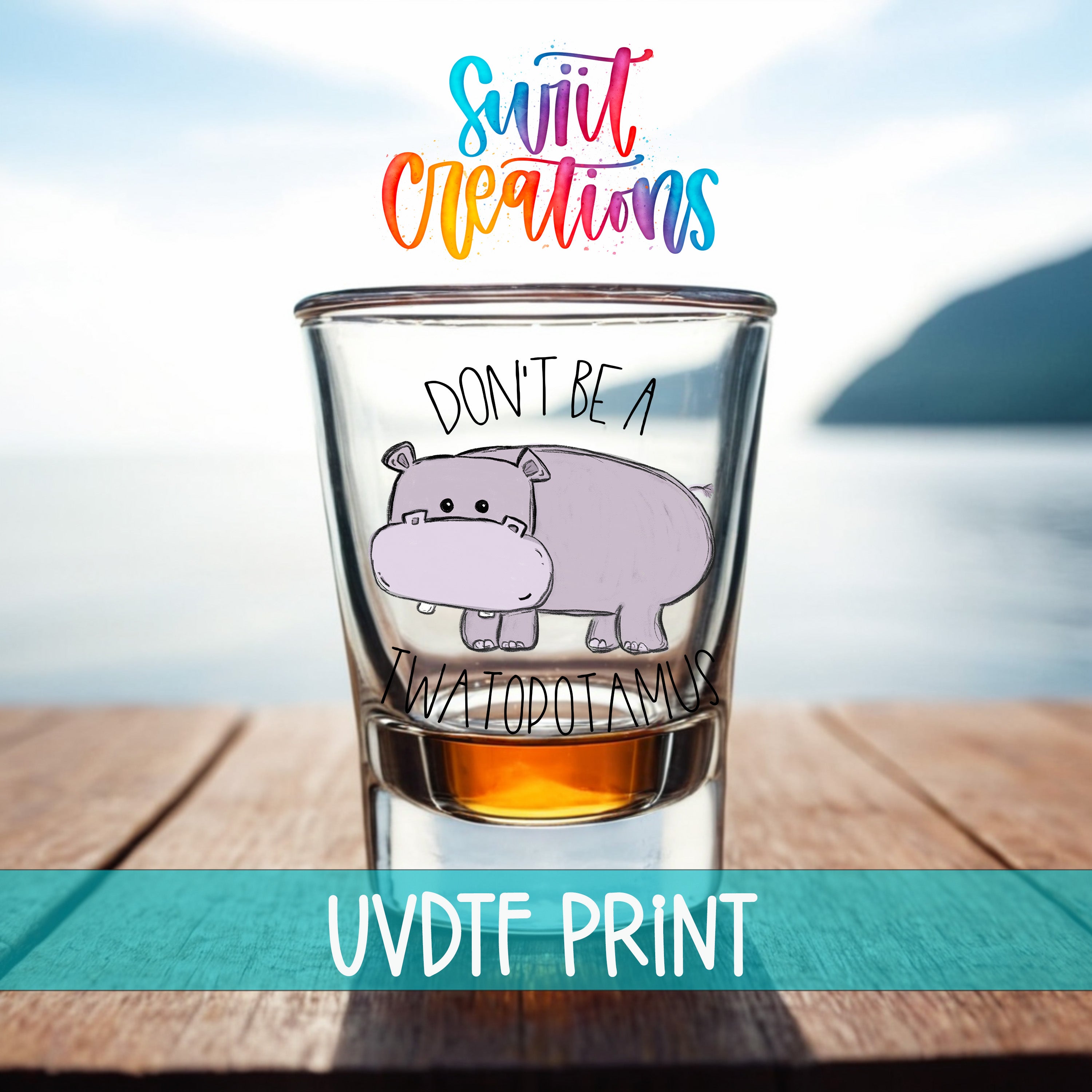 a shot glass with a cartoon hippopotamus and the text "DON'T BE A TWATODOTAMUS" printed on it.