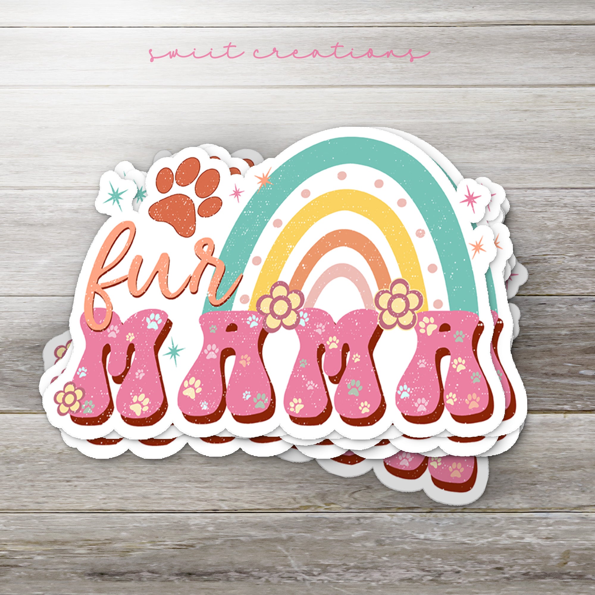 a sticker with a rainbow and paw prints on it