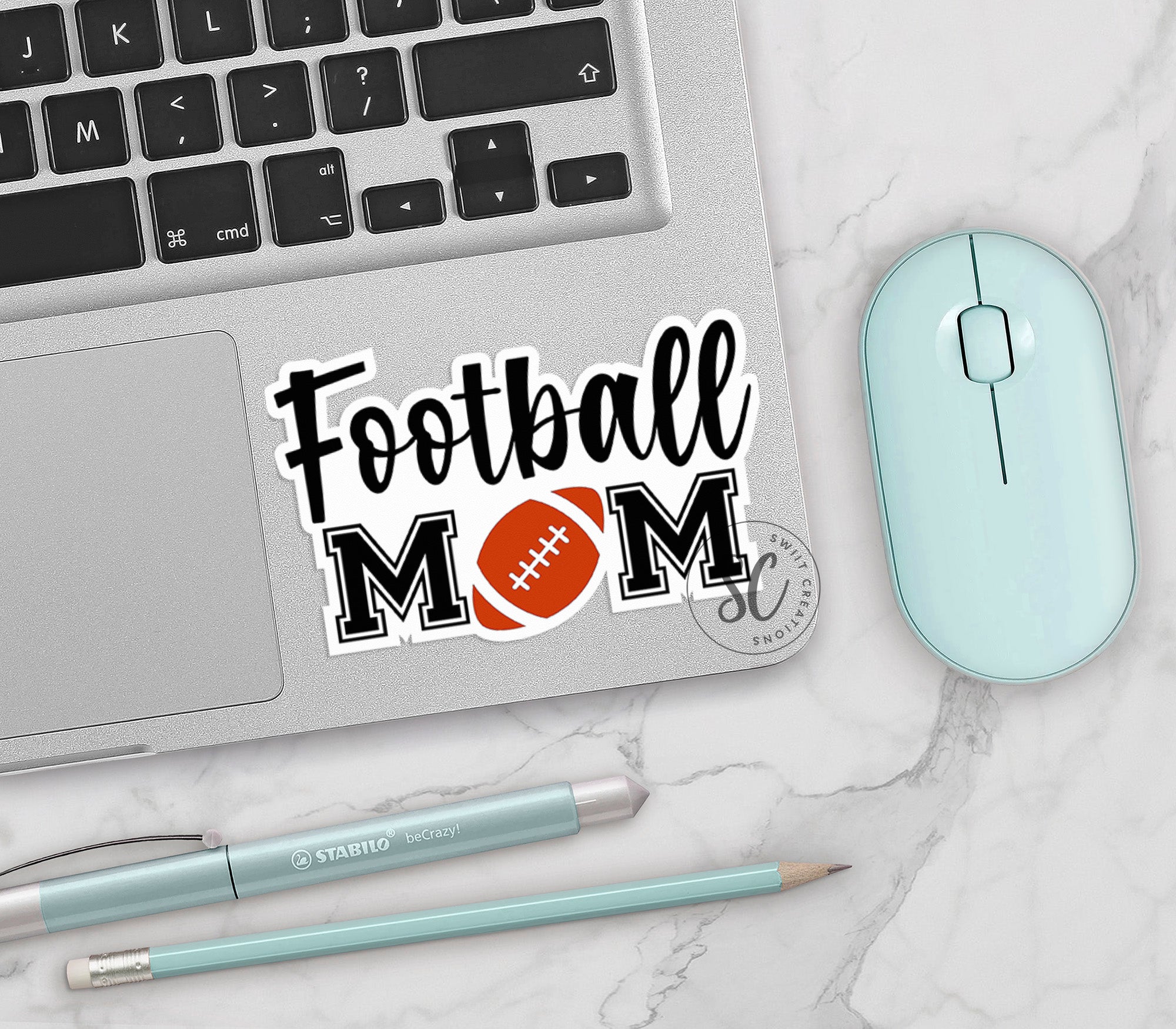 a laptop with a football mom sticker on it