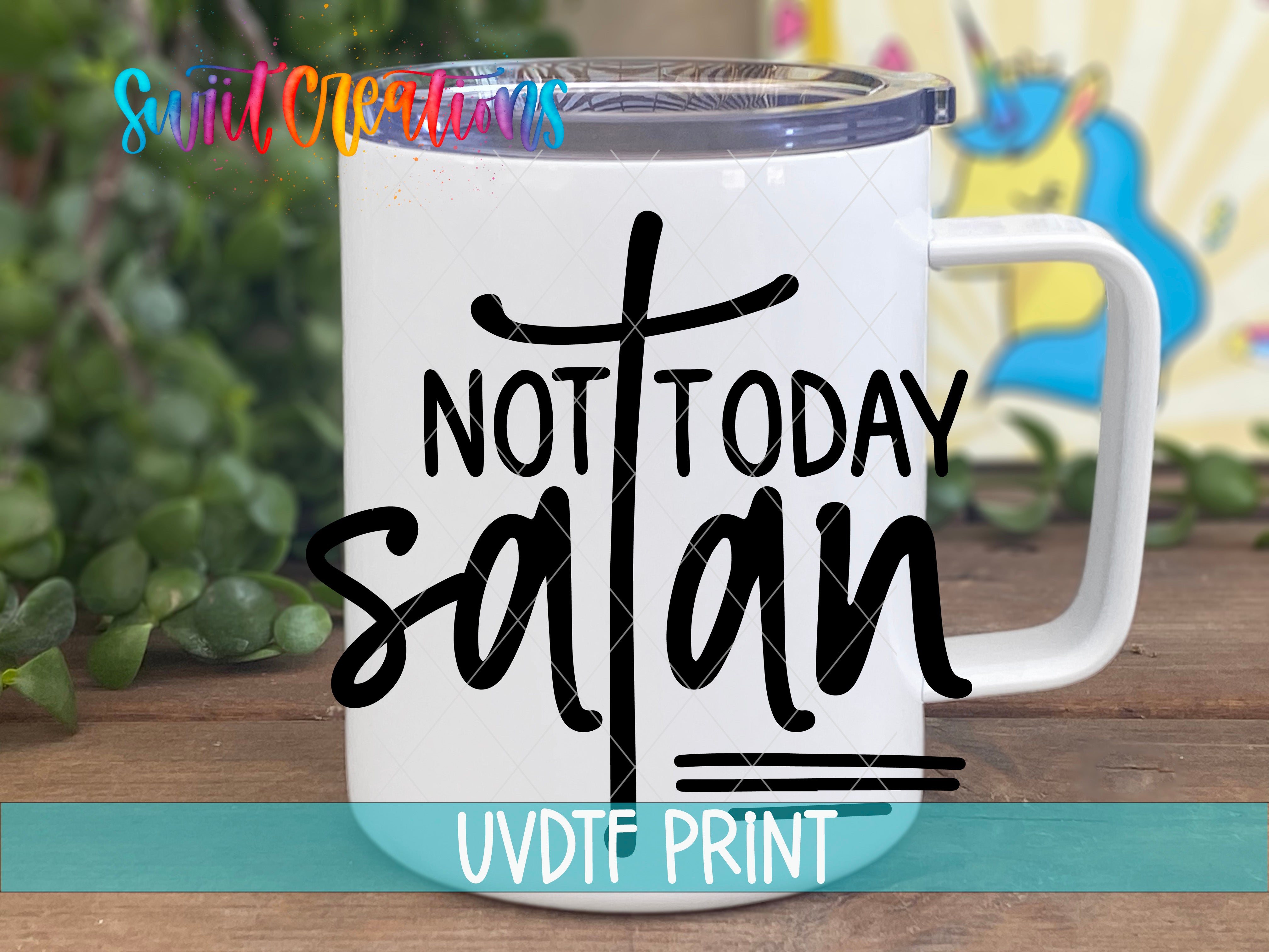 A white mug with a printed text design on it, placed on a wooden surface.