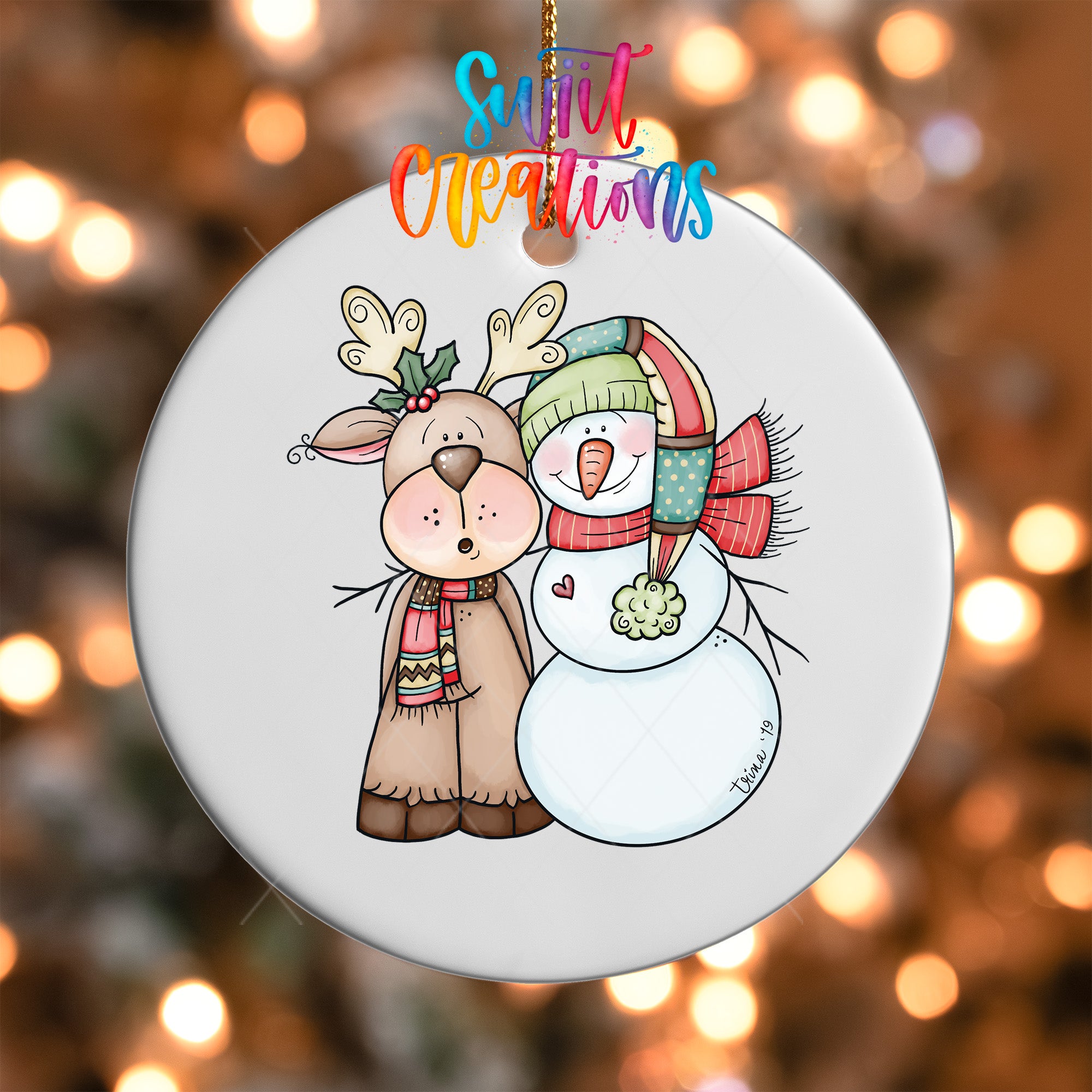 A white ornament featuring a cartoon illustration of a reindeer and a snowman, with the text "Sweet Creations" above them.