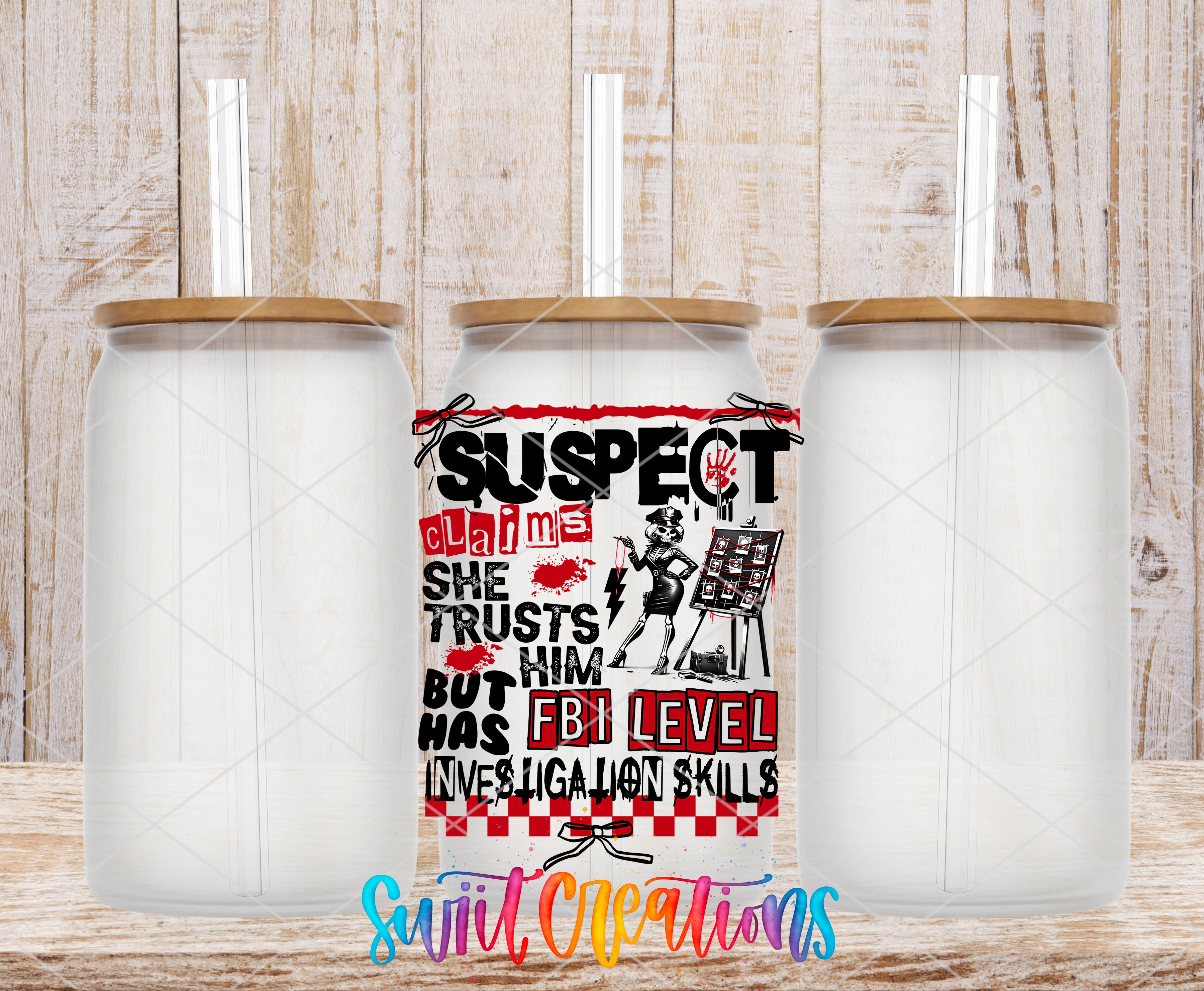 three glass jars with lids, each containing a straw. The jars are arranged in a row, with the middle jar having a colorful, artistic design on it.