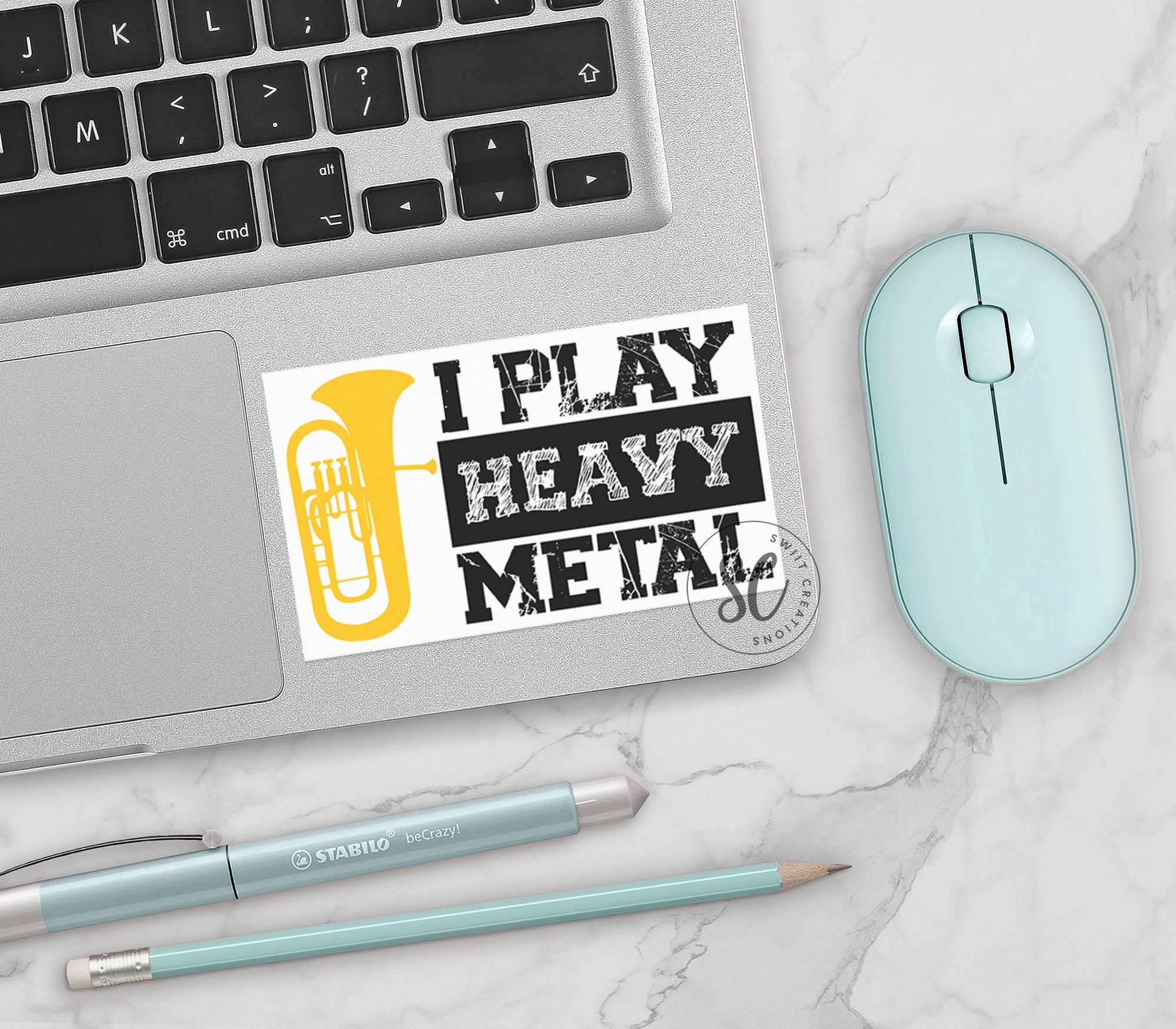 a keyboard, mouse, and sticker on a table