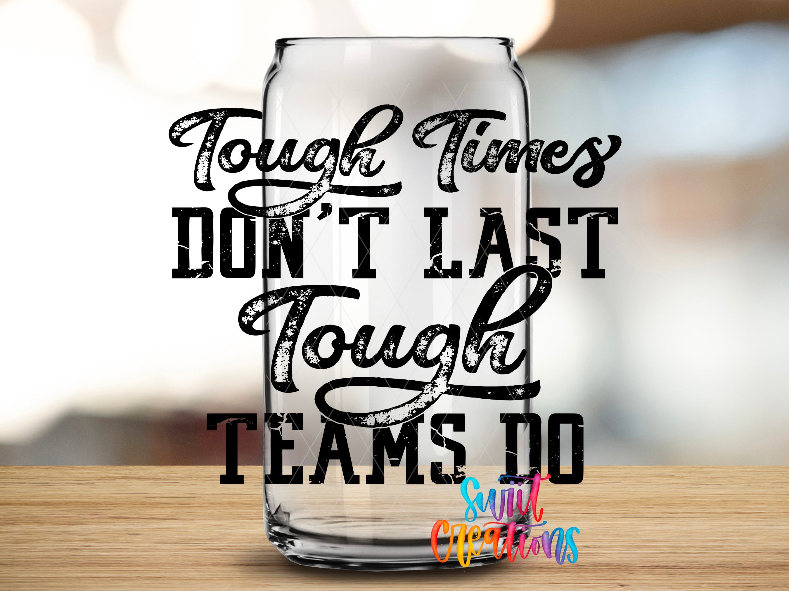 a clear glass can with bold text printed on it, which reads "Tough times don't last tough times teams do".