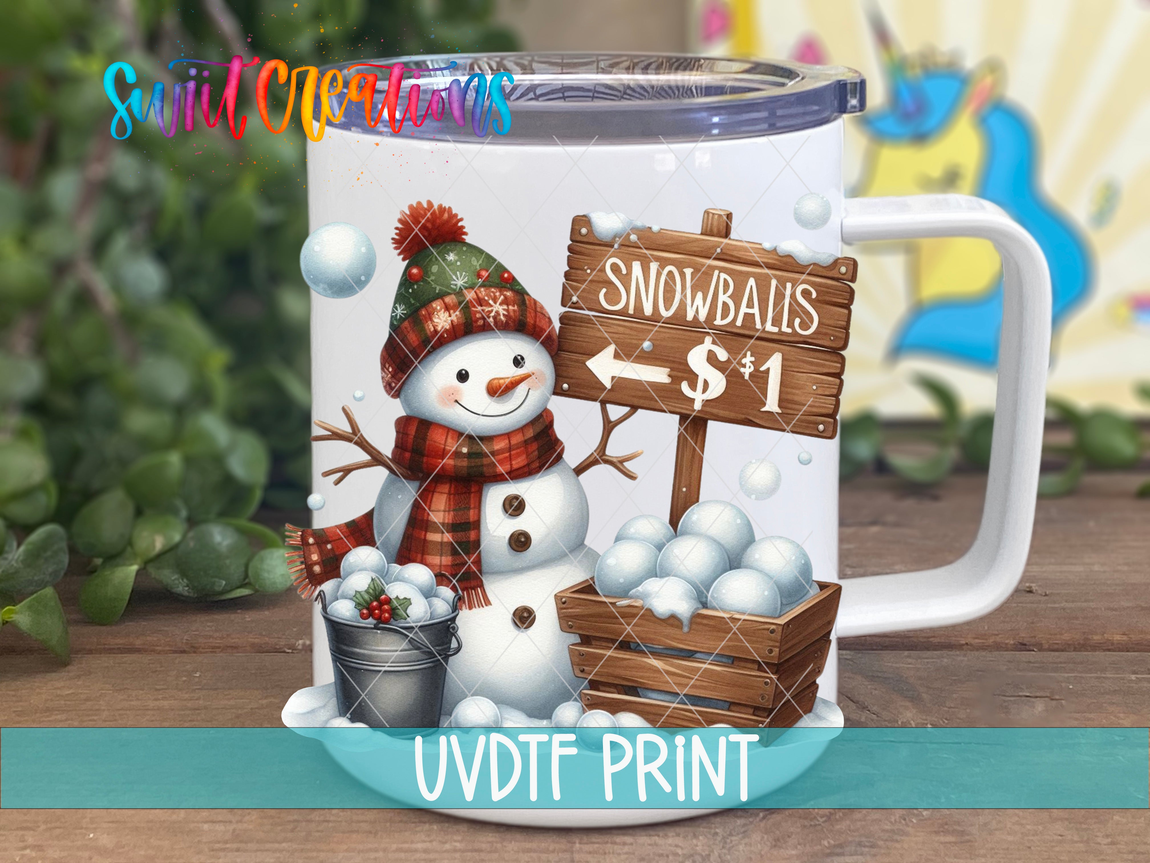 A mug with a snowman and snowballs on it, along with a sign advertising snowballs for $1.
