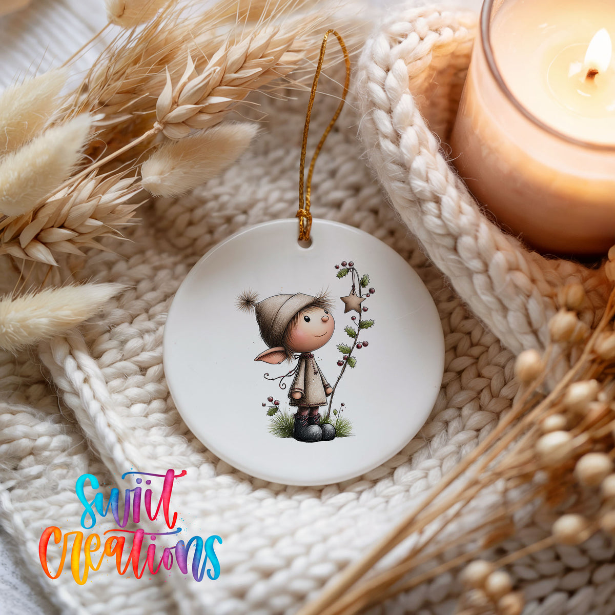 a white ceramic ornament with a whimsical illustration of a small elf-like character, surrounded by dried flowers and a lit candle.