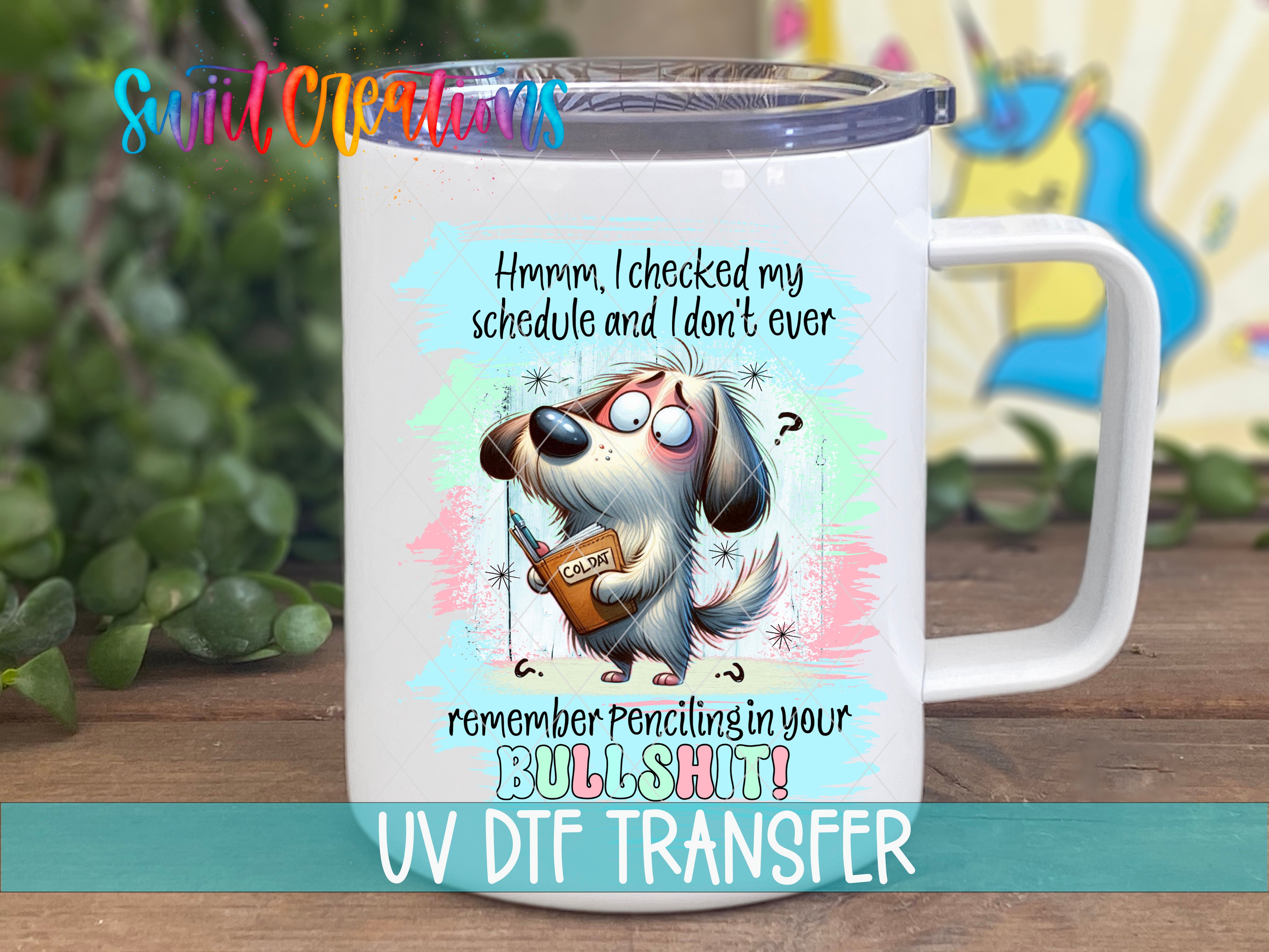 A white mug with a cartoon dog and text on it, placed on a wooden surface.