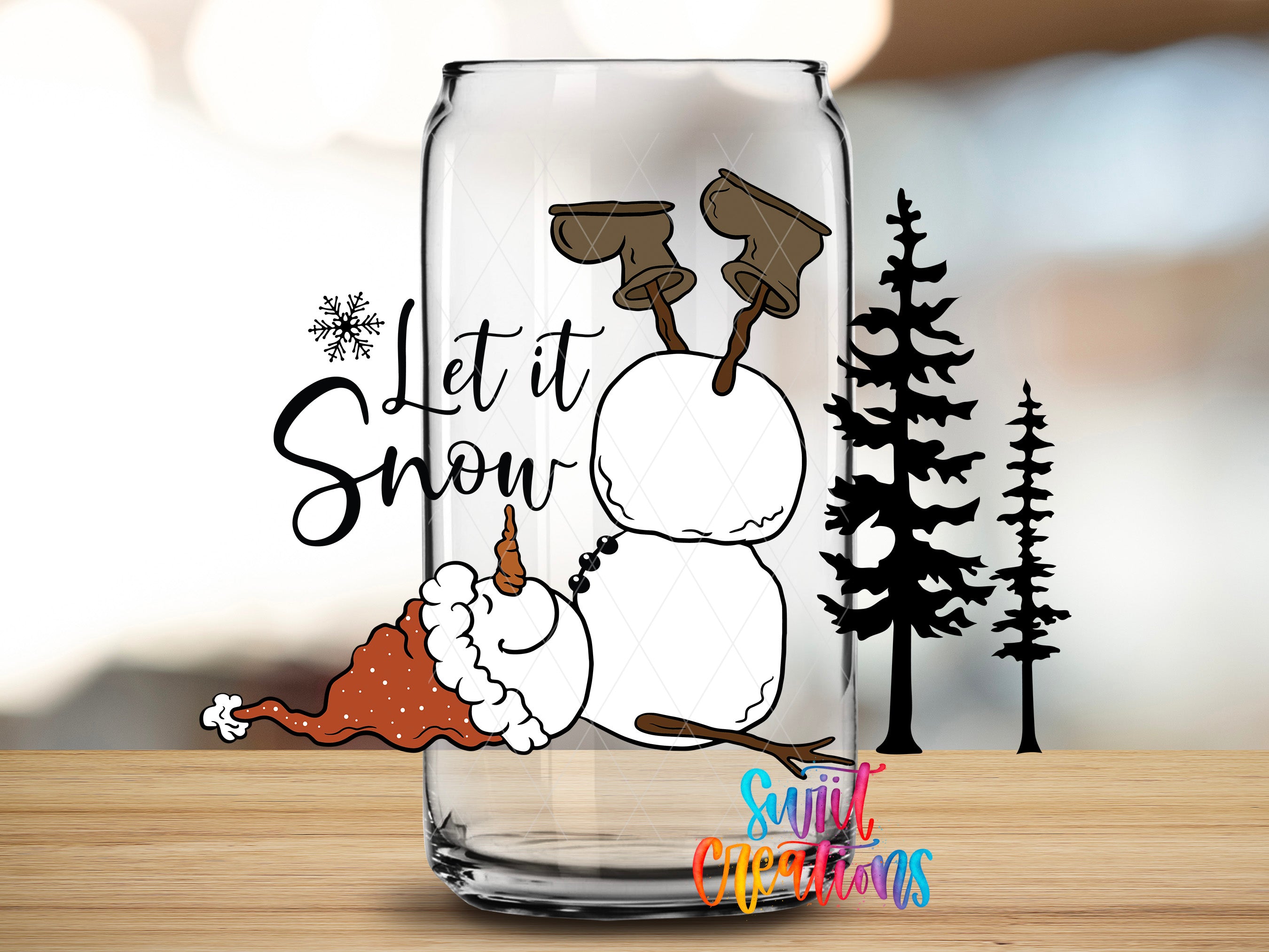 A glass jar with a snowman and pine trees on it, along with the text "Let it Snow" and a snowflake design.