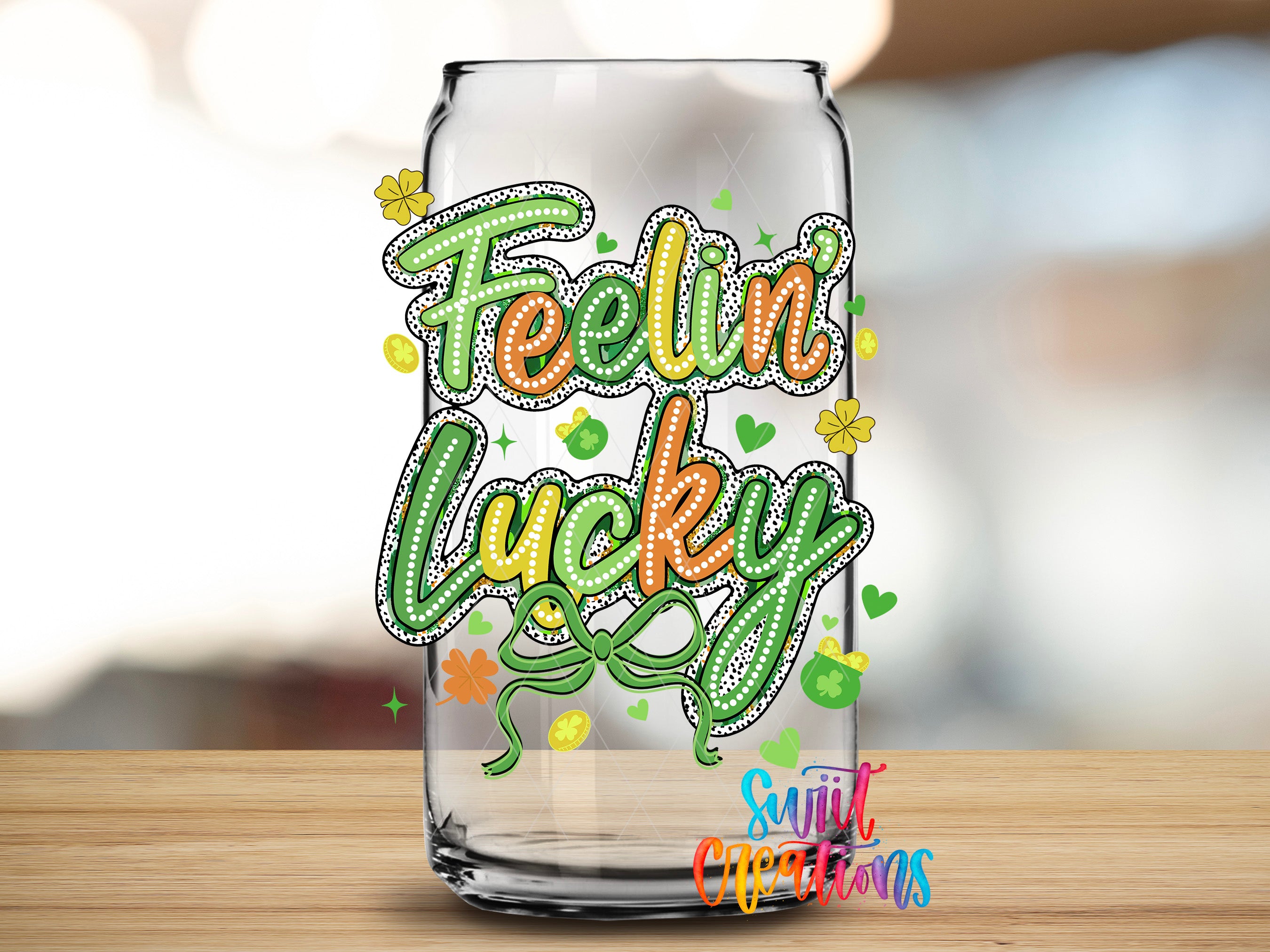 A glass can with a colorful and whimsical design featuring the text "Feelin' Lucky" surrounded by various decorative elements such as hearts, flowers, and stars.