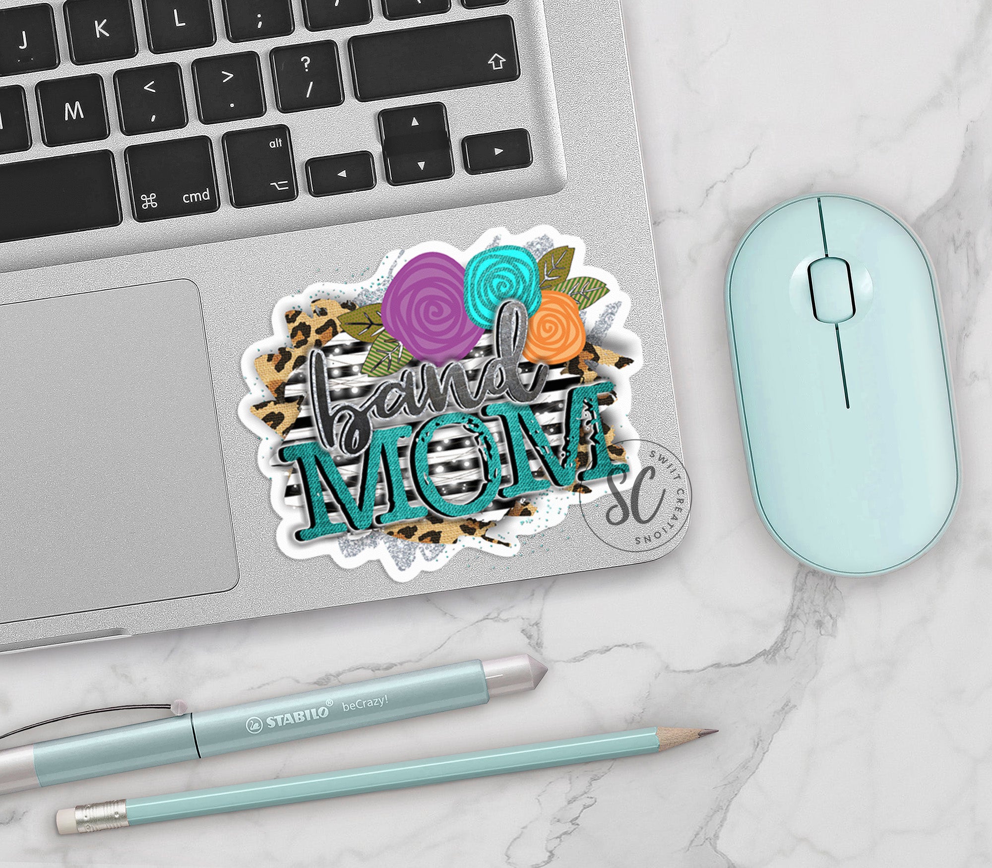 a laptop computer sitting next to a mouse