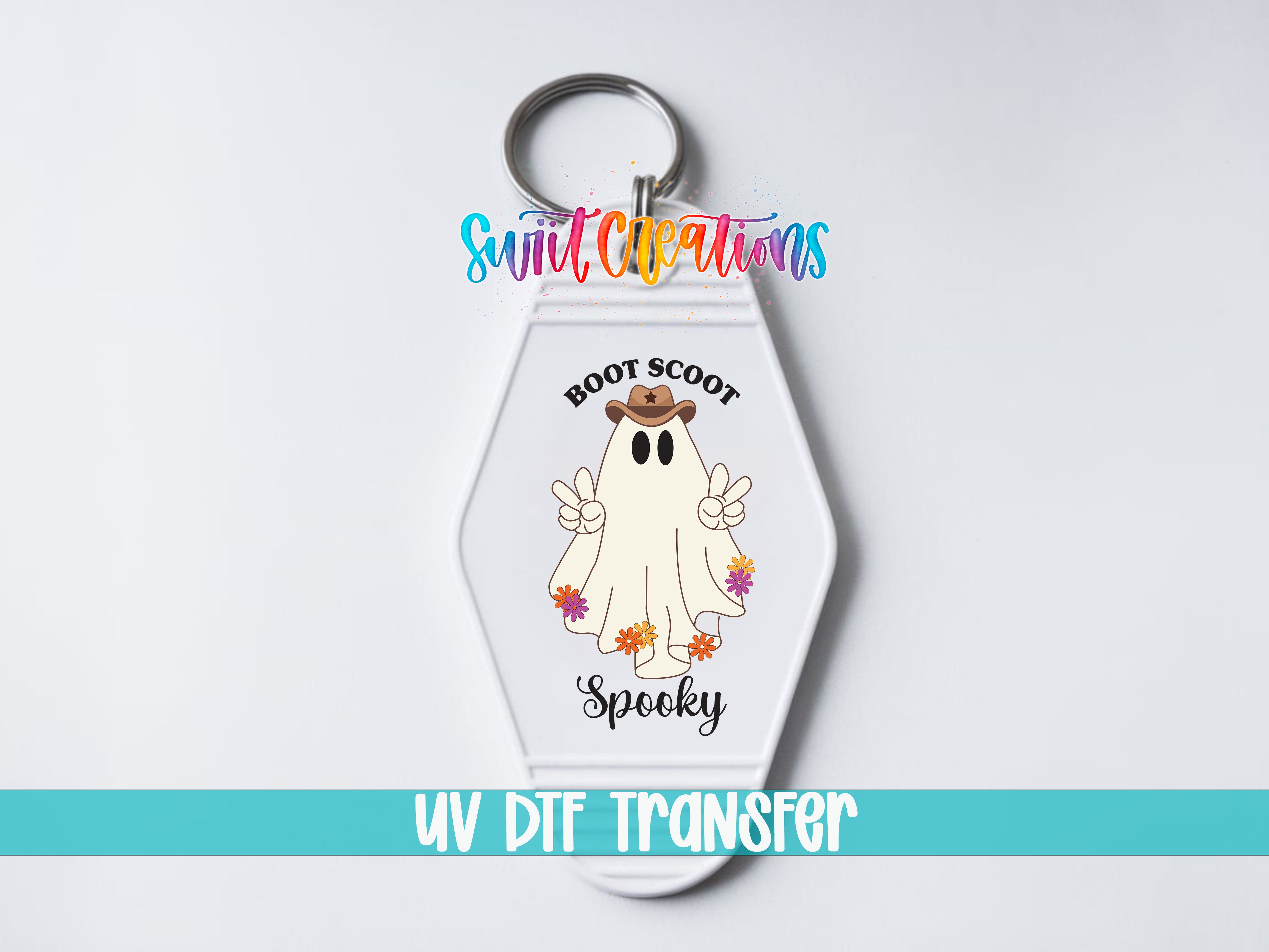 A keychain with a cartoon ghost wearing a cowboy hat and the text "Boots Scoot Spooky" printed on it.