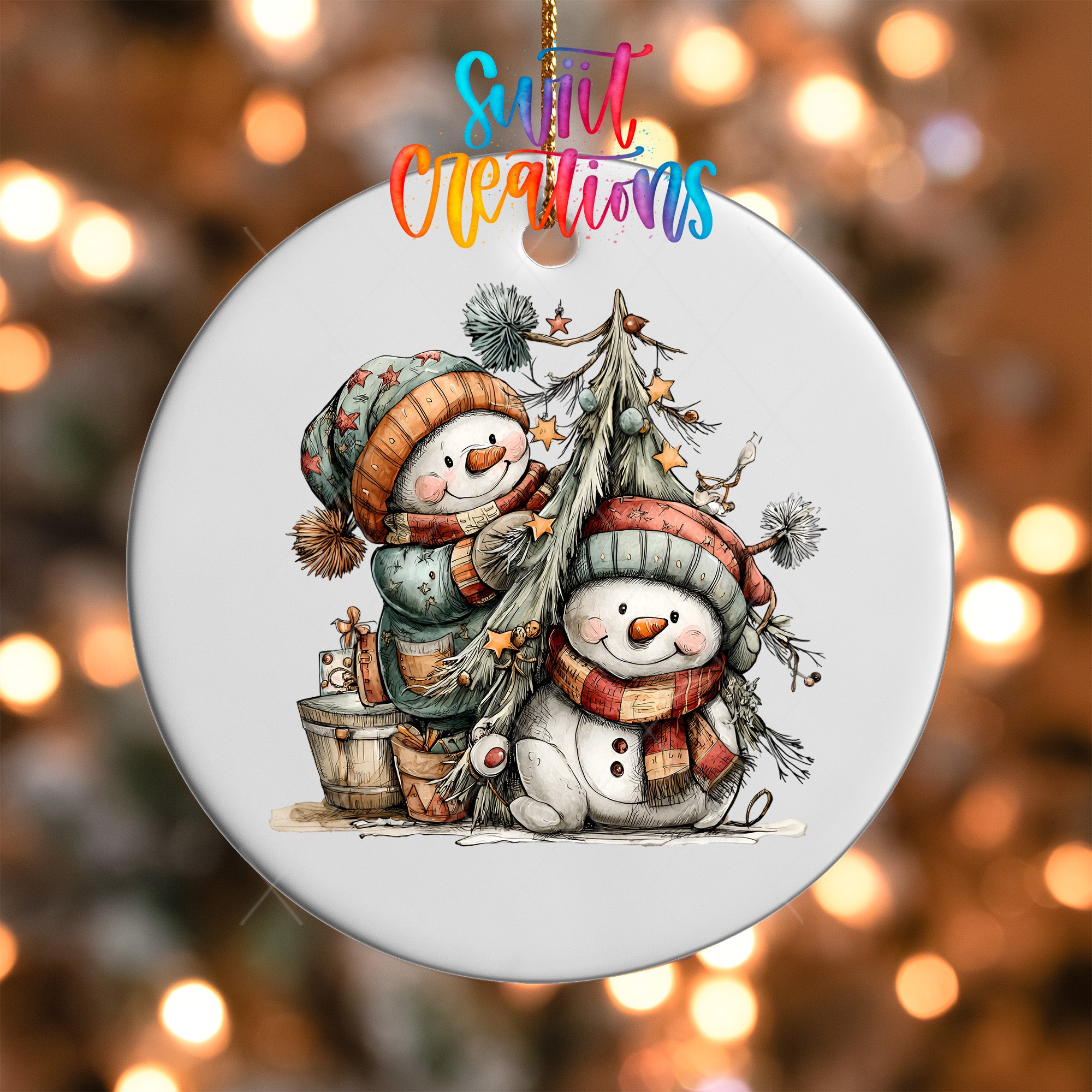 A white ornament with a snowman and a tree, surrounded by festive decorations and twinkling lights.