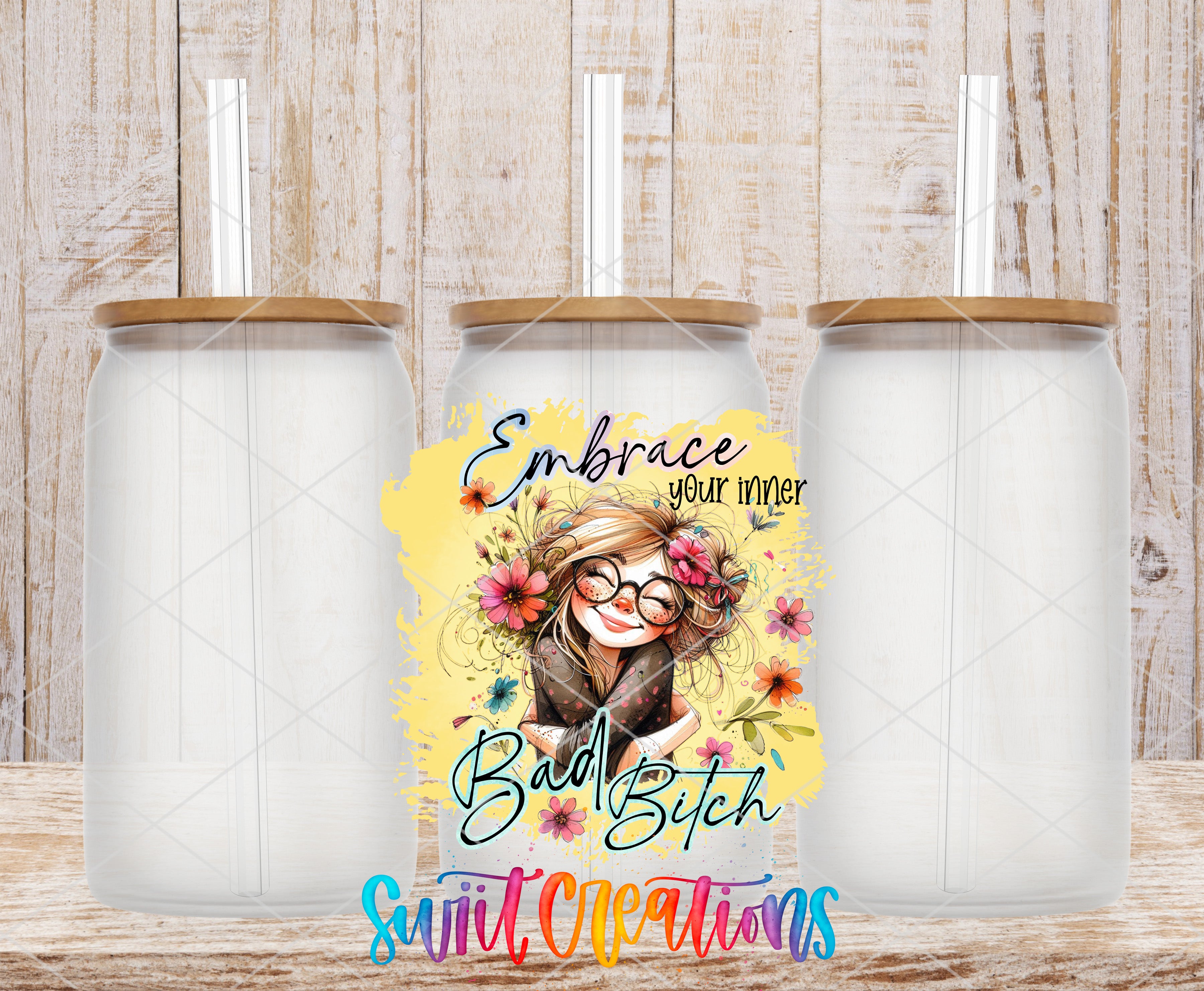 three clear glass jars with wooden lids, each with a straw sticking out of the top. In the center of the image, there is a colorful illustration of a woman with glasses and a flower in her hair, accompanied by the text "Embrace your inner bad girl" and "Swift Creations".