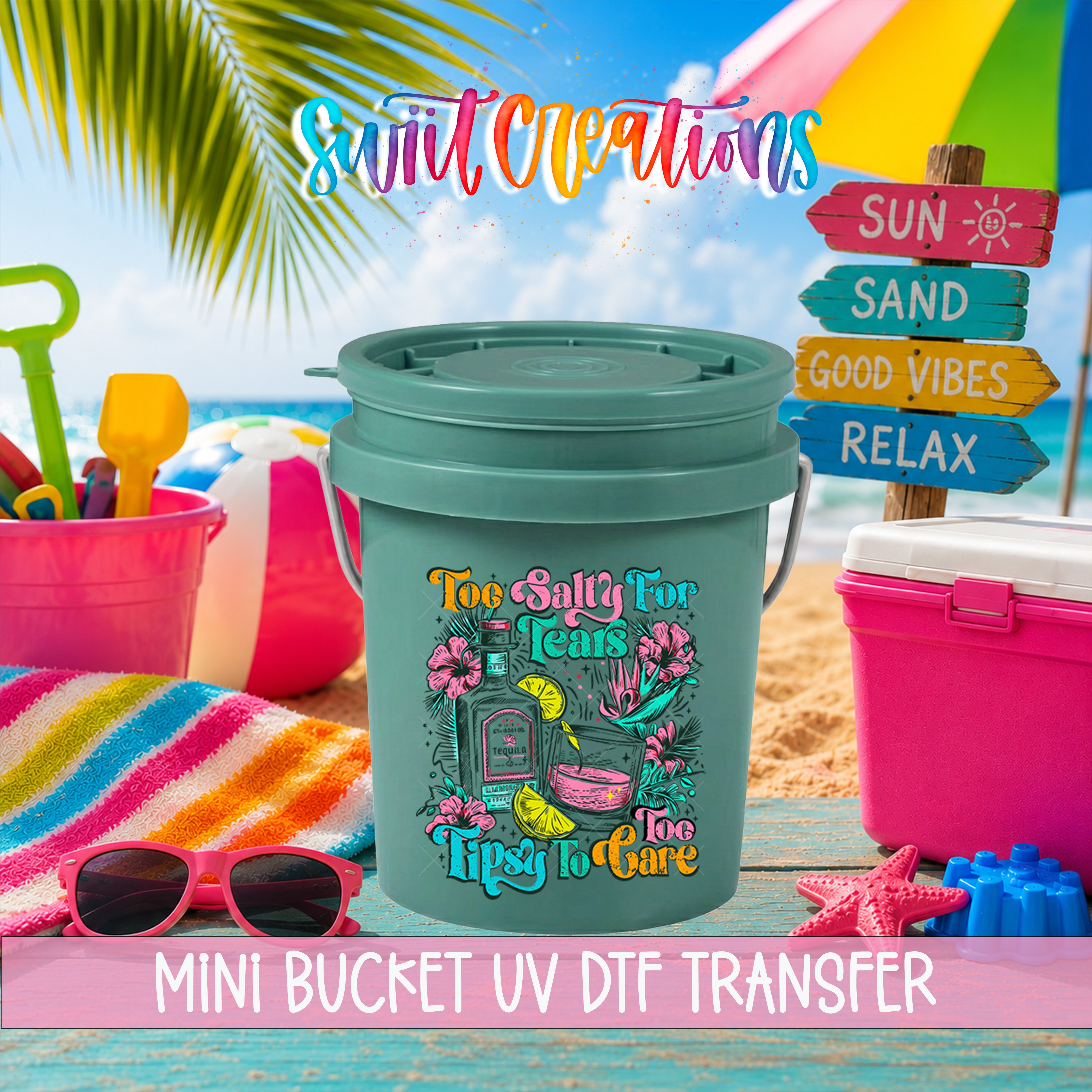 A colorful bucket with a lid, surrounded by beach toys and accessories, with a sign that says "Mini Bucket UV Dtf Transfer" and a palm tree in the background.