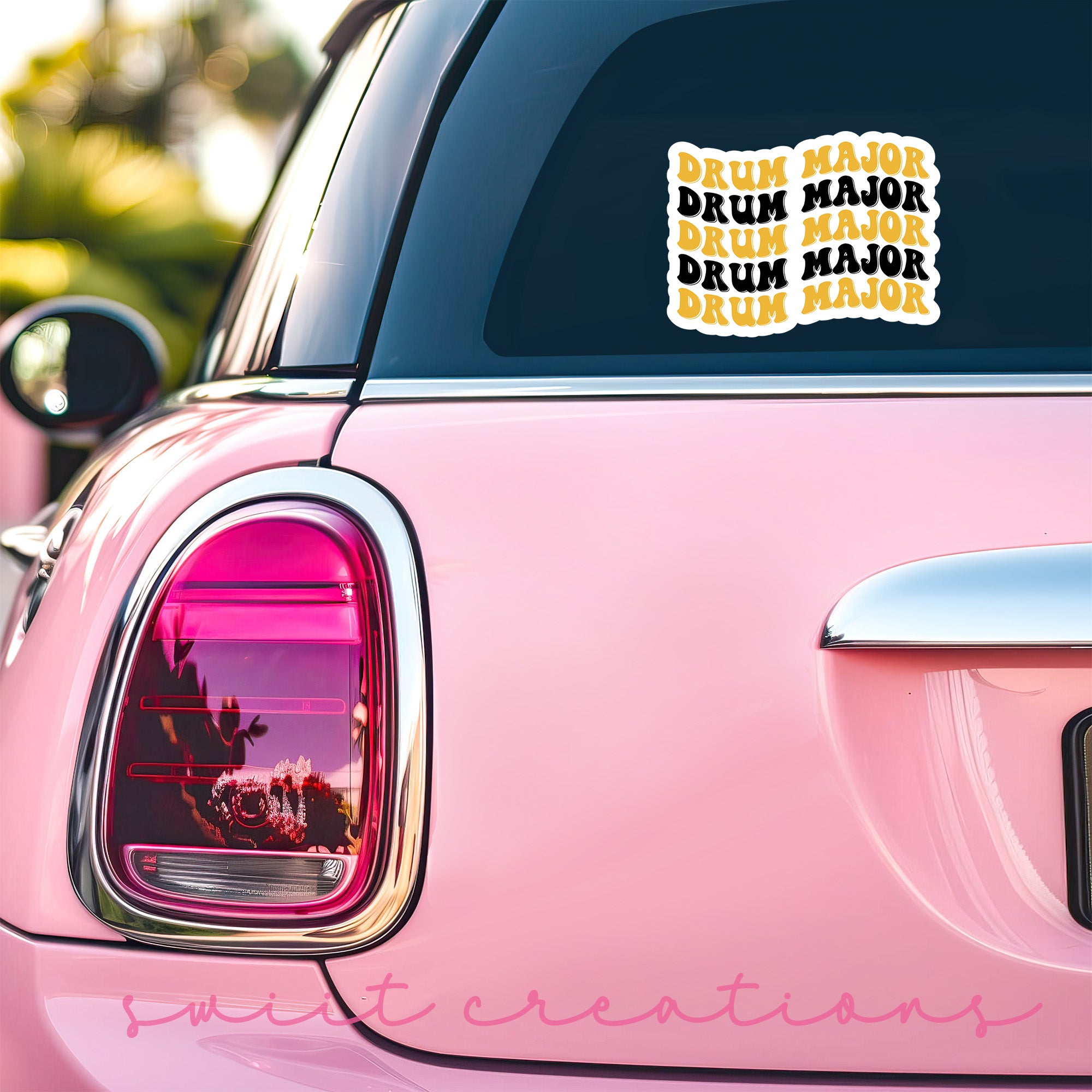 a pink car with a sticker on it